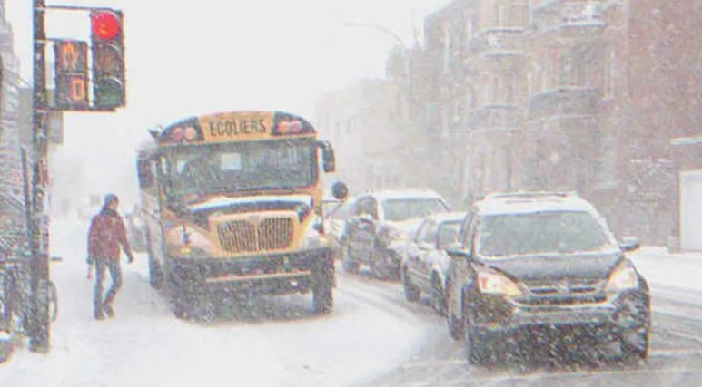 A bus in traffic on a snowy day | Source: Shutterstock