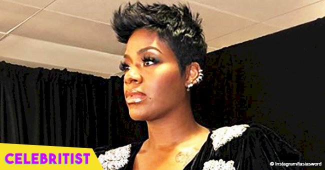 Fantasia Barrino flaunts her curves & tattooed legs in tight black mini-dress while dancing in video