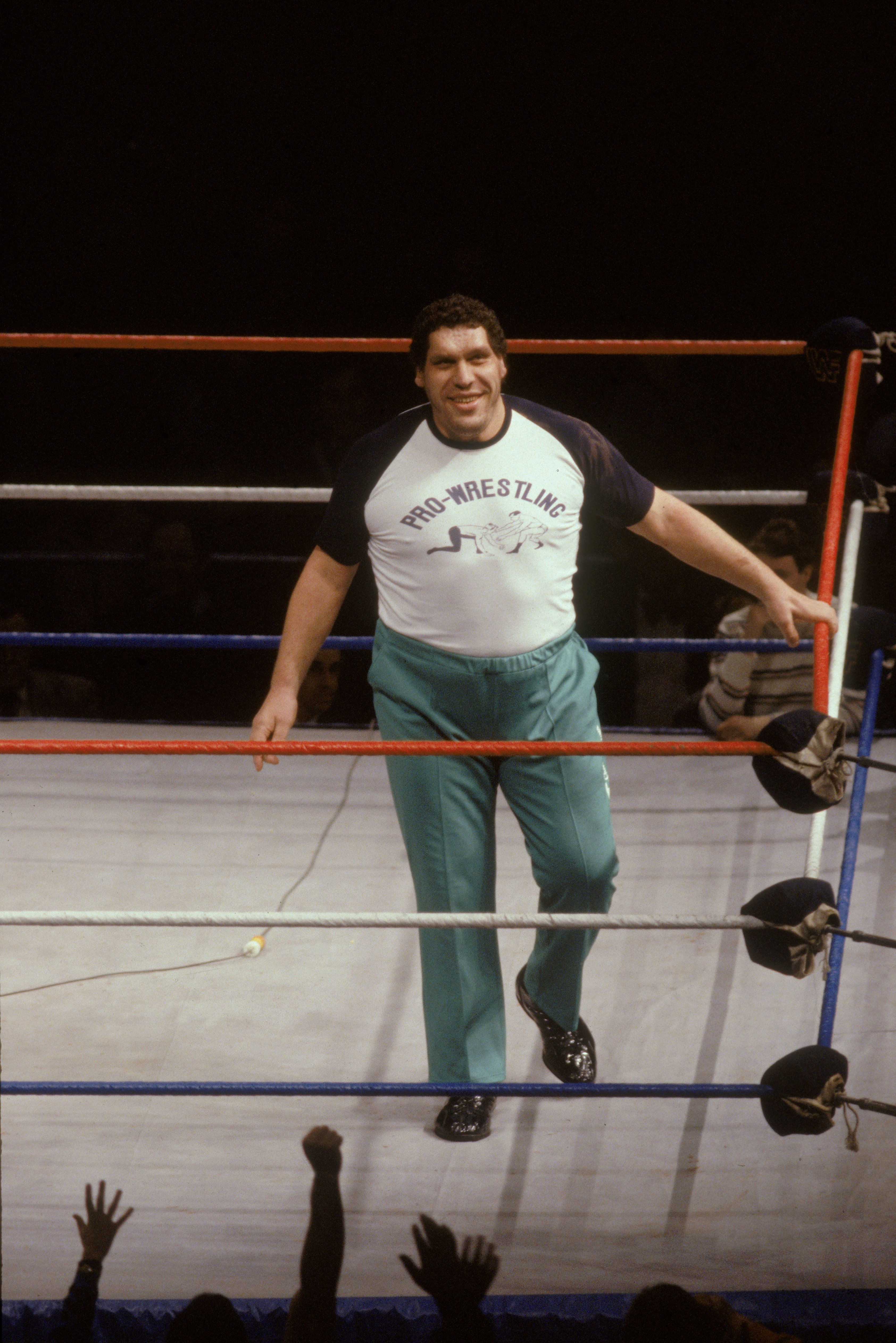 Andre the Giant (1946 - 1993) is photographed smiling as he walks around in the ring, as a special guest referee for the match with Rowdy Roddy Piper and Adrian Adonis on January 30, 1987 | Source: Getty Images