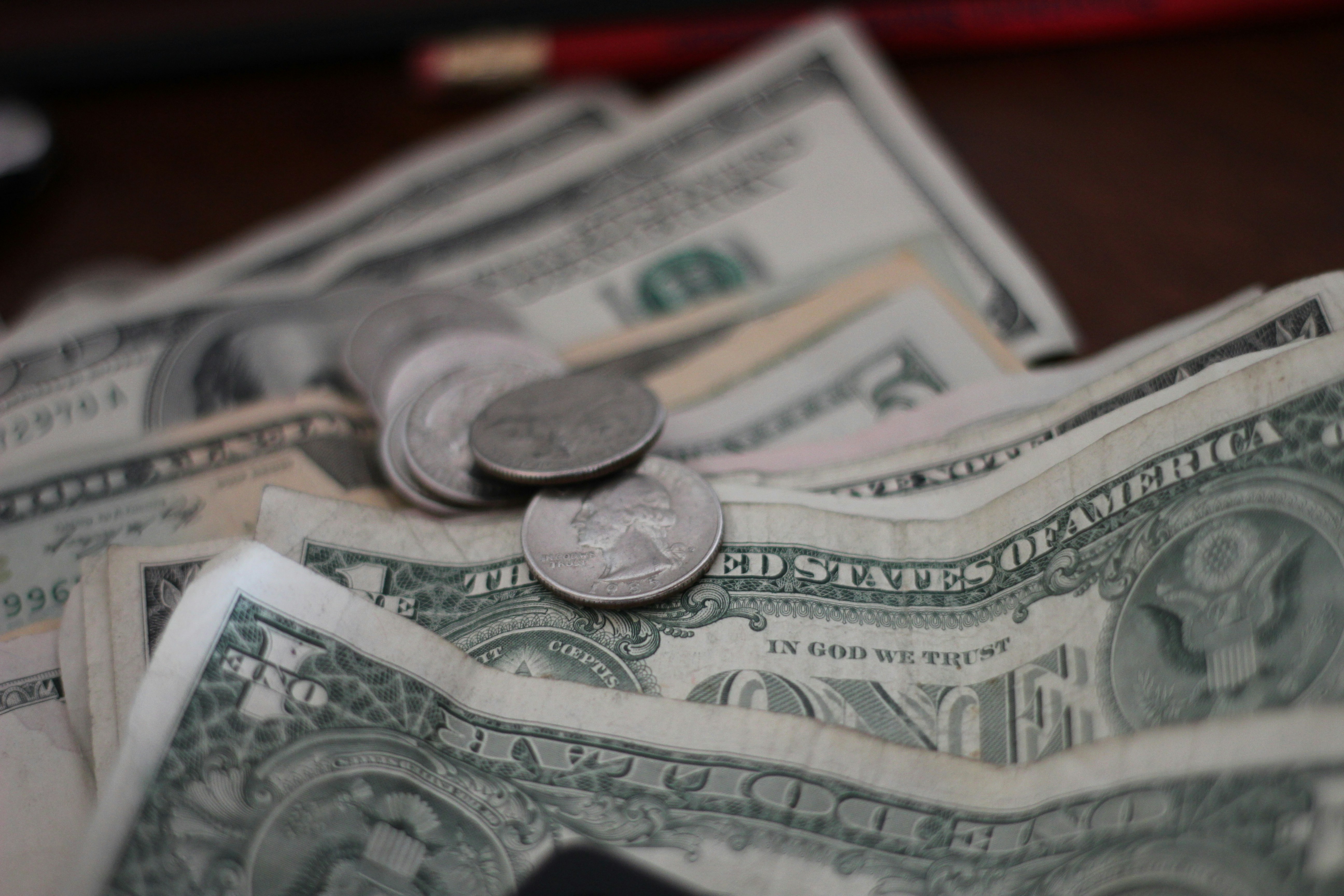 A close-up of dollars and coins | Source: Unsplash