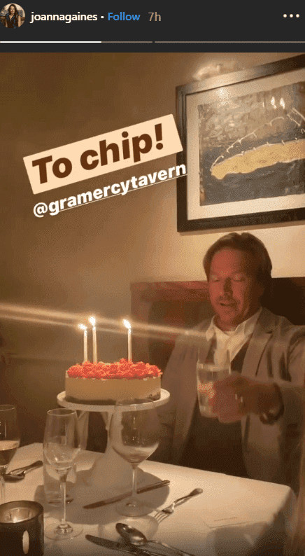Chip Gaines smiles in front of a red berry topped cheese cake for his 45th birthday dinner celebration | Source: Instagram.com/joannagaines