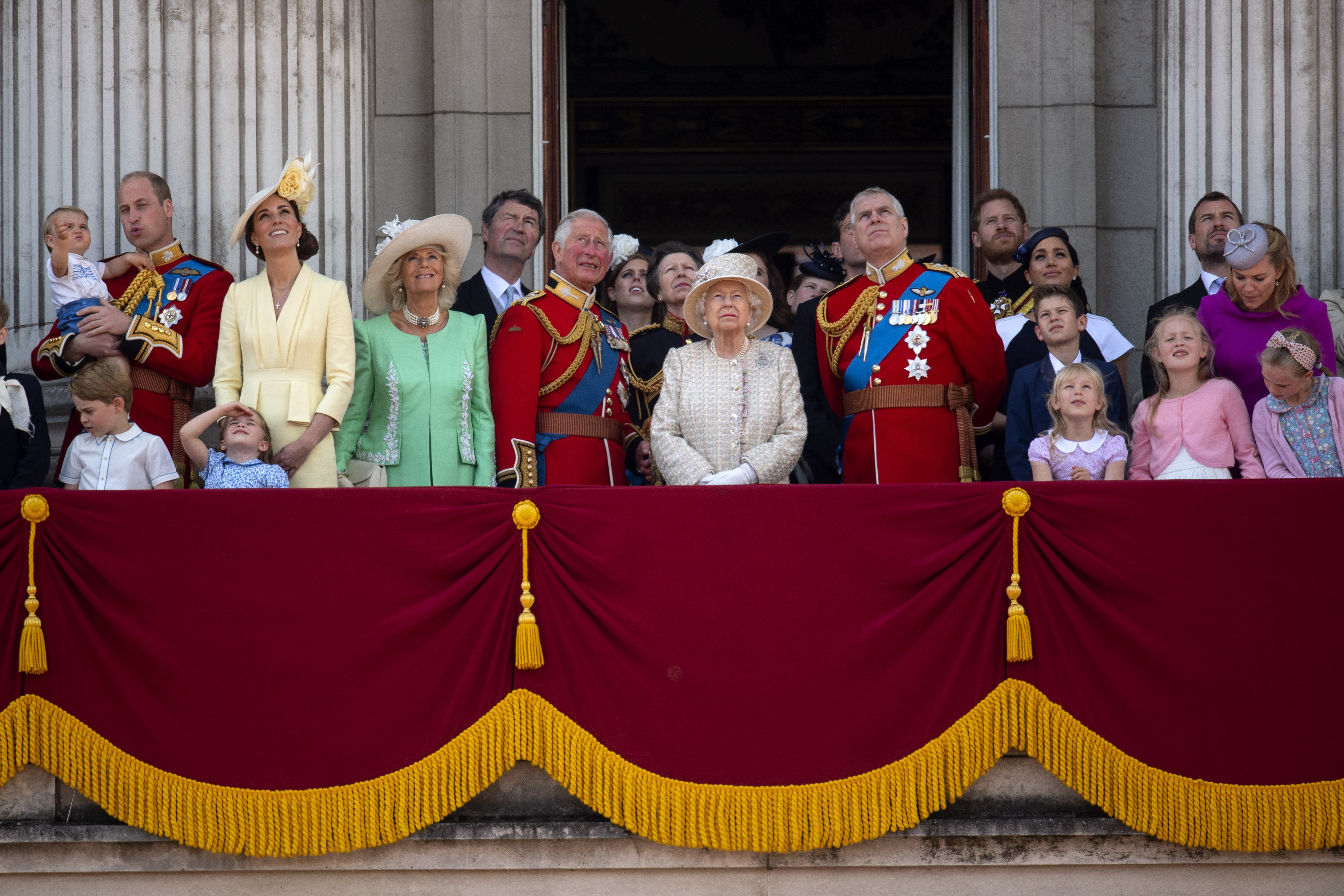 Queen Elizabeth II is joined by members of the royal family, including the Duke and Duchess of Cambridge with their children, Prince Louis, Prince George, Princess Charlotte, Duchess of Cornwall, Prince of Wales, Princess Royal, Duke of York, Duke and Duchess of Sussex, Peter and Autumn Phillips and their children Savannah and Isla, on the balcony of Buckingham Place watch the flypast after the Trooping the Colour ceremony, as she celebrates her official birthday. | Source: Getty Images