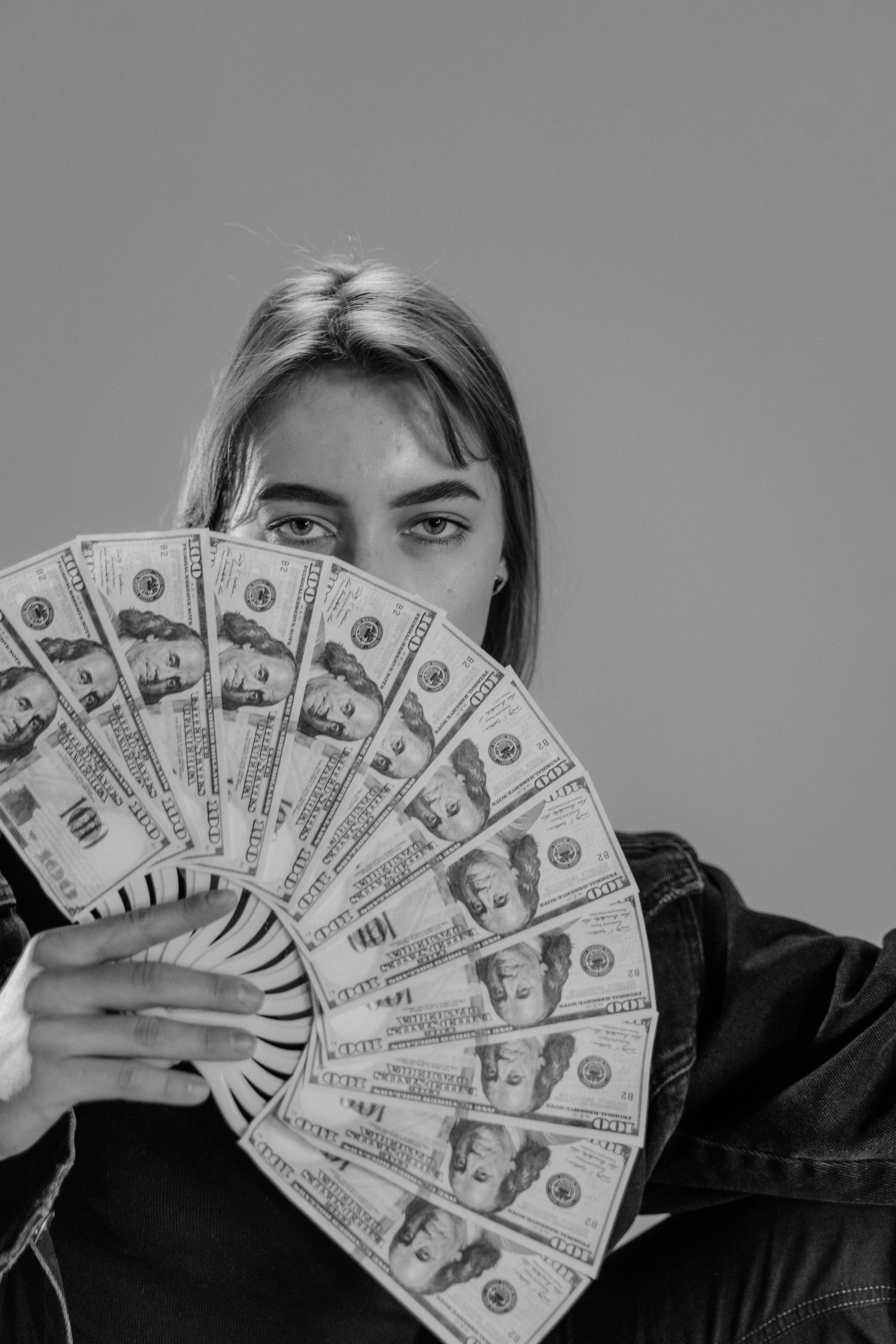 A woman fanning herself with money | Source: Pexels