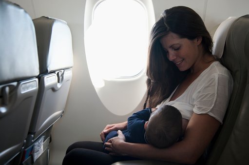 Mother breastfeeding her child on an airplane | Photo: Getty Images