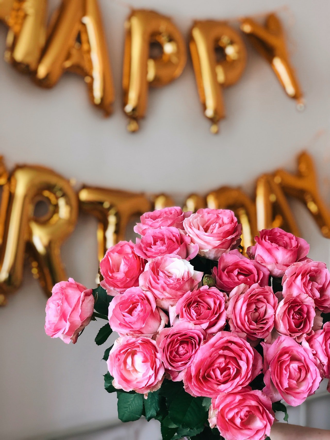 Beautiful flowers with birthday balloons in the background | Photo: Pexels