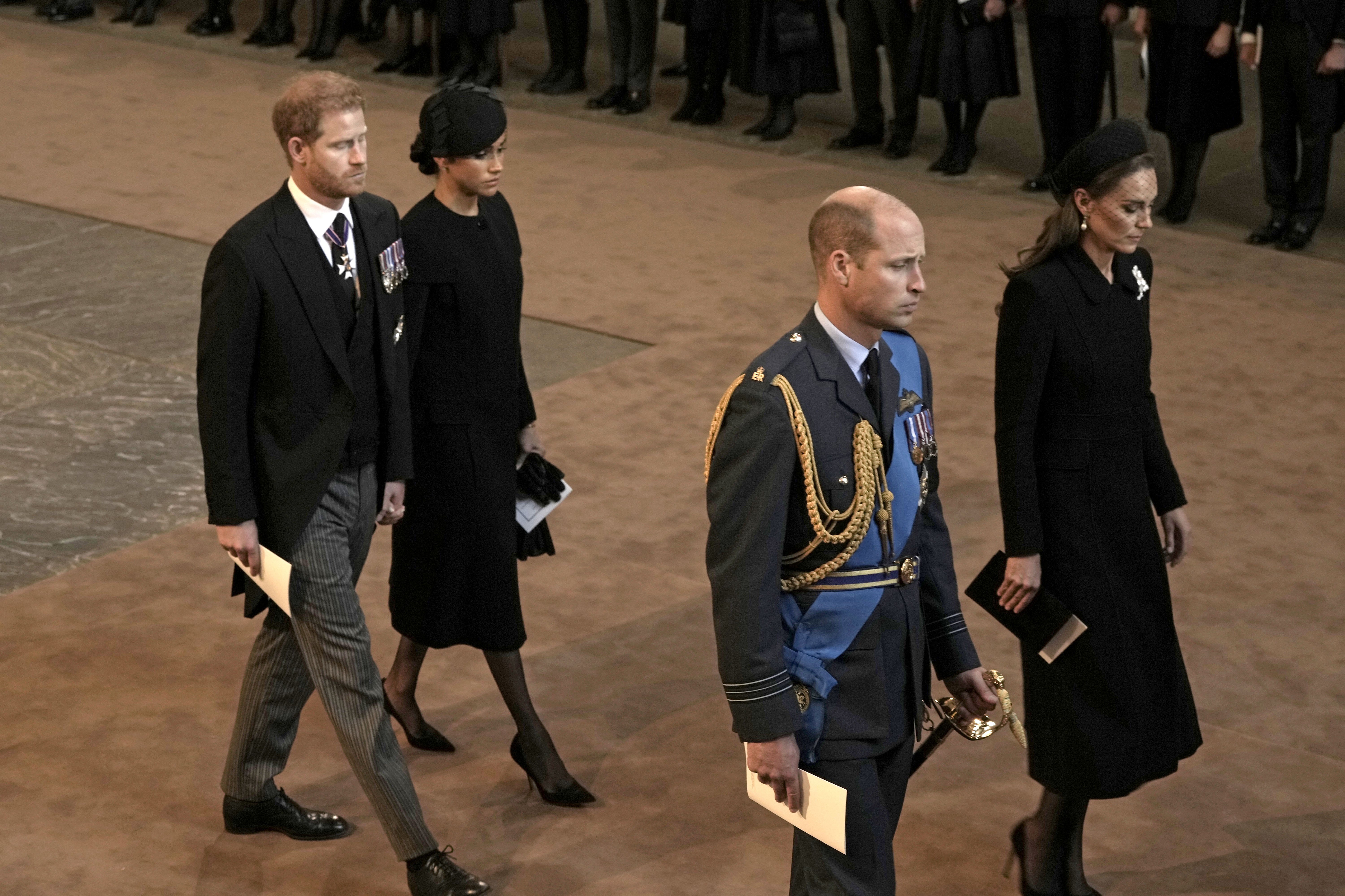(L-R) Prince Harry, Meghan Markle, Prince William and Kate Middleton leave Westminster Hall on September 14, 2022 in London, United Kingdom ┃Source: Getty Images