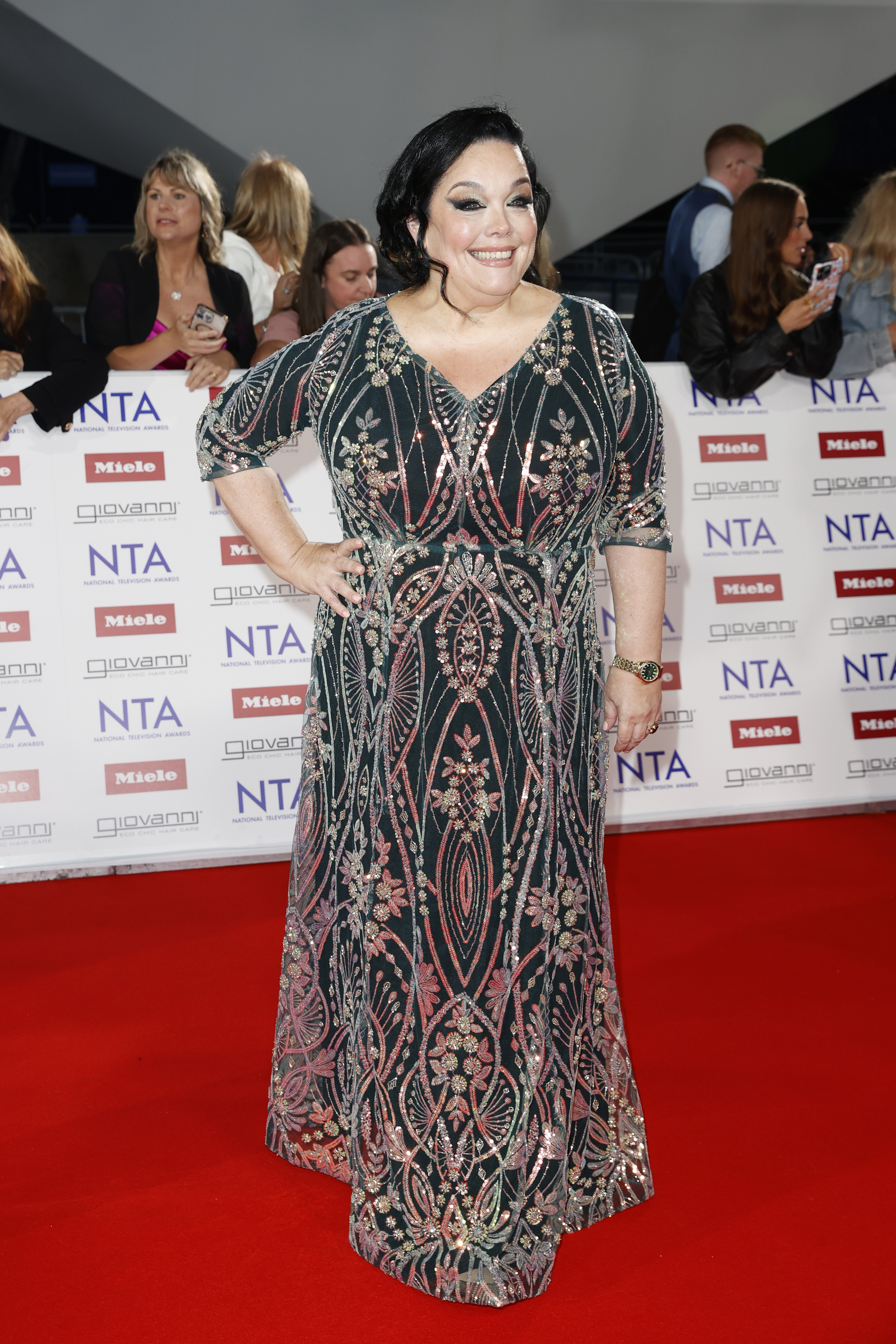 Lisa Riley stunned on the red carpet at the National Television Awards in London on September 10, 2025, wearing an intricately embellished floor-length gown in jewel tones. Radiating confidence, the actor showcased the results of a near decade-long transformation — having dropped 12 stone, undergone multiple surgeries, and lost a further 20 pounds during her time on "I'm a Celebrity...Get Me Out of Here!"