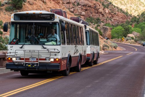Two shuttle buses en route to their destination. | Source: Shutterstock.