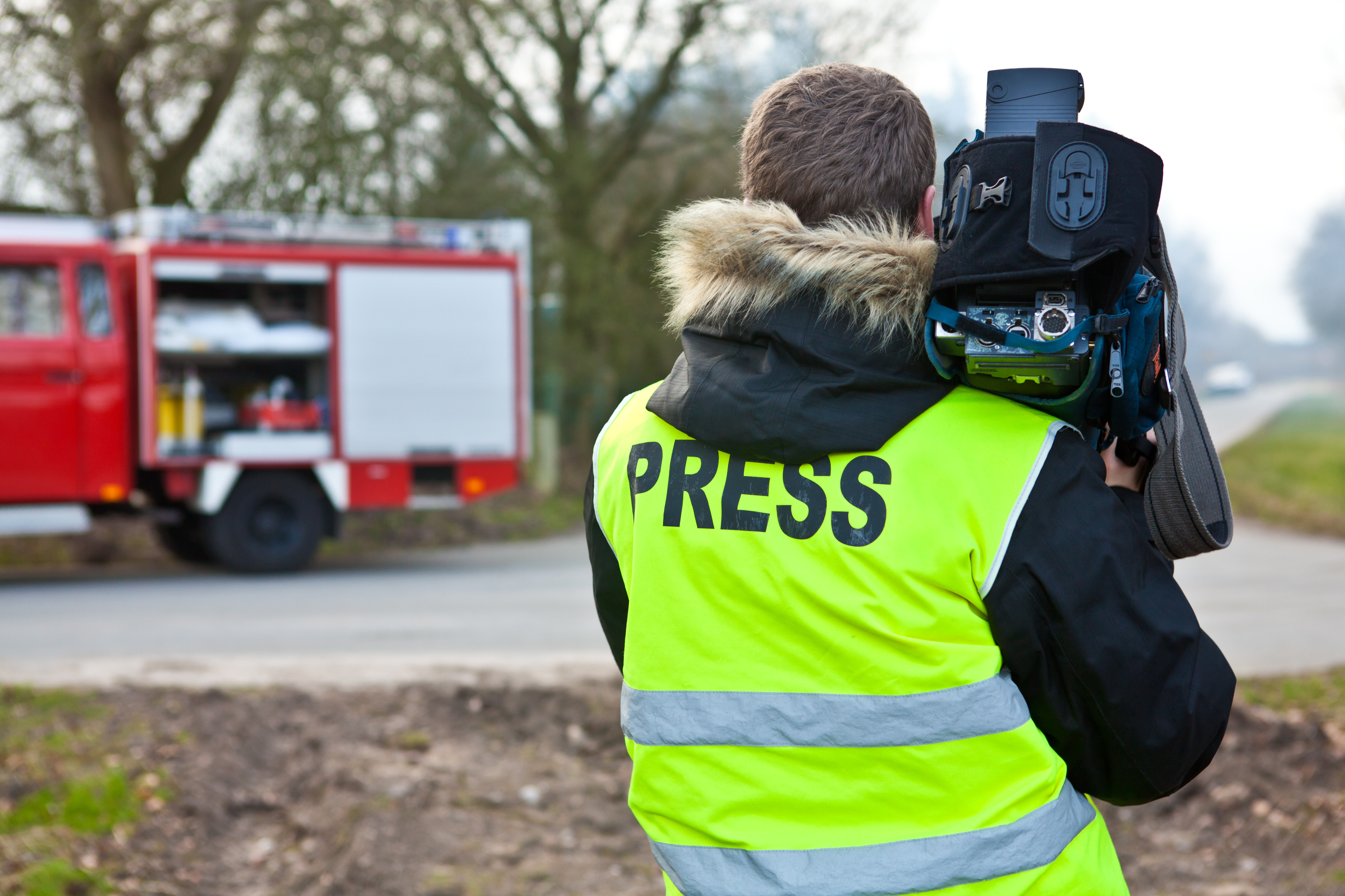 journalist with camera  | Shutterstock
