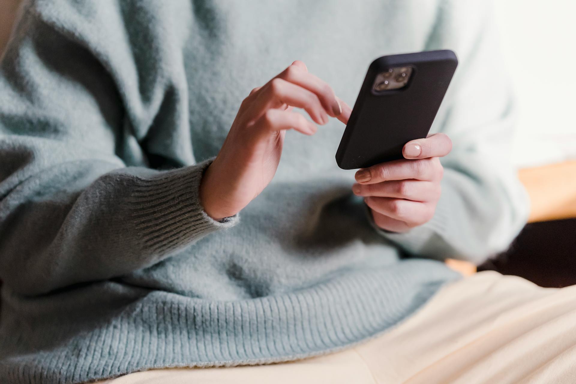 A woman scrolling on her phone | Source: Pexels