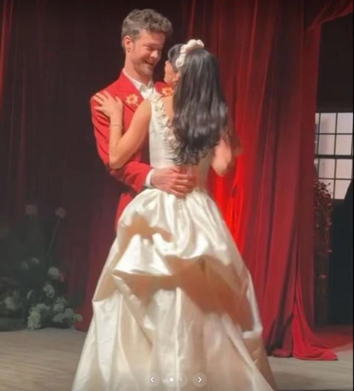 Jack Quaid and Claudia Doumit lean in close on stage, sharing an intimate near-kiss moment as they take their first dance on their wedding day. | Source: TikTok/news.com.au