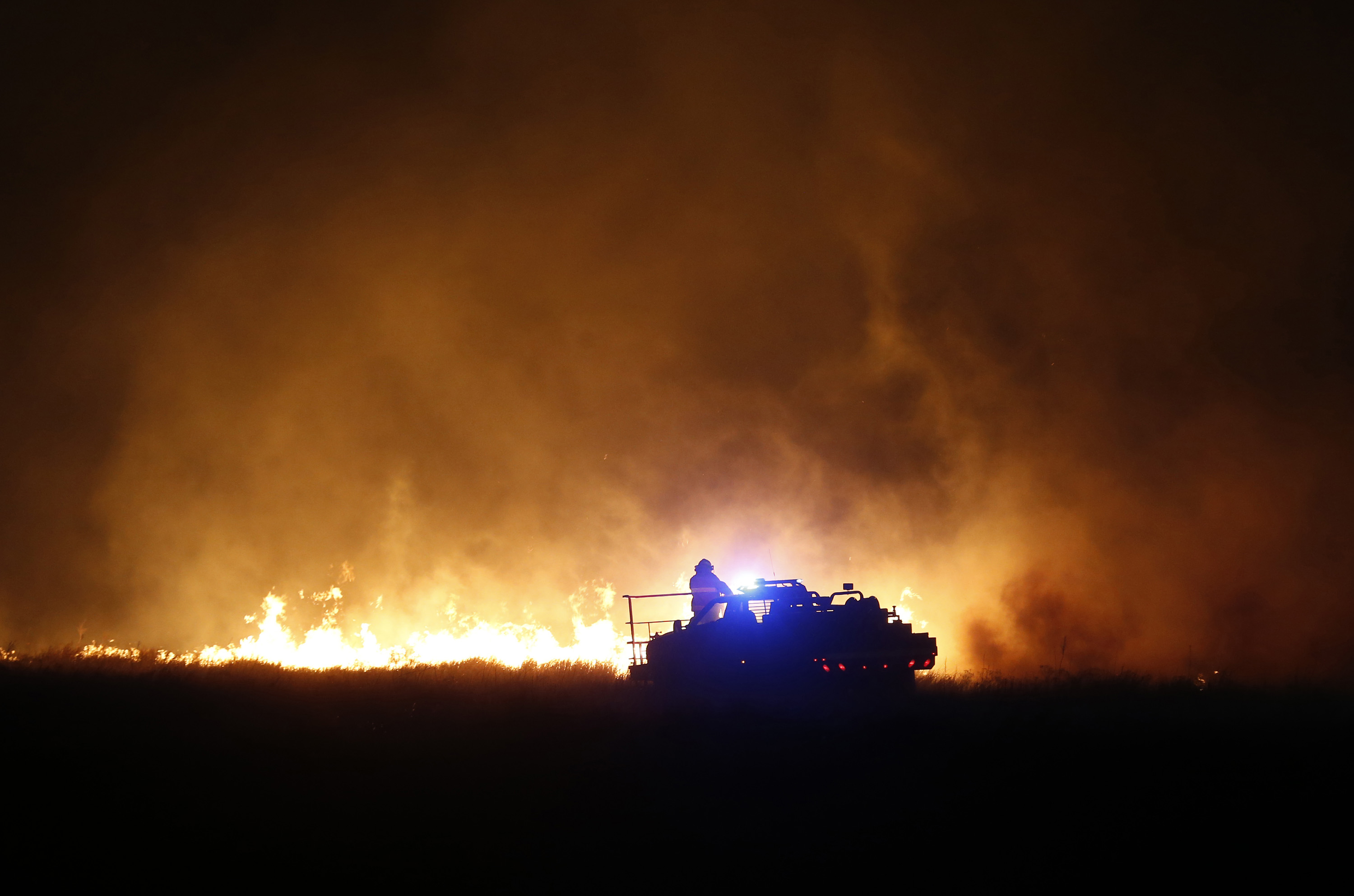 Firefighters from across Kansas and Oklahoma battle a major wildfire near Protection, Kan, on March 7, 2017 | Source: Getty Images