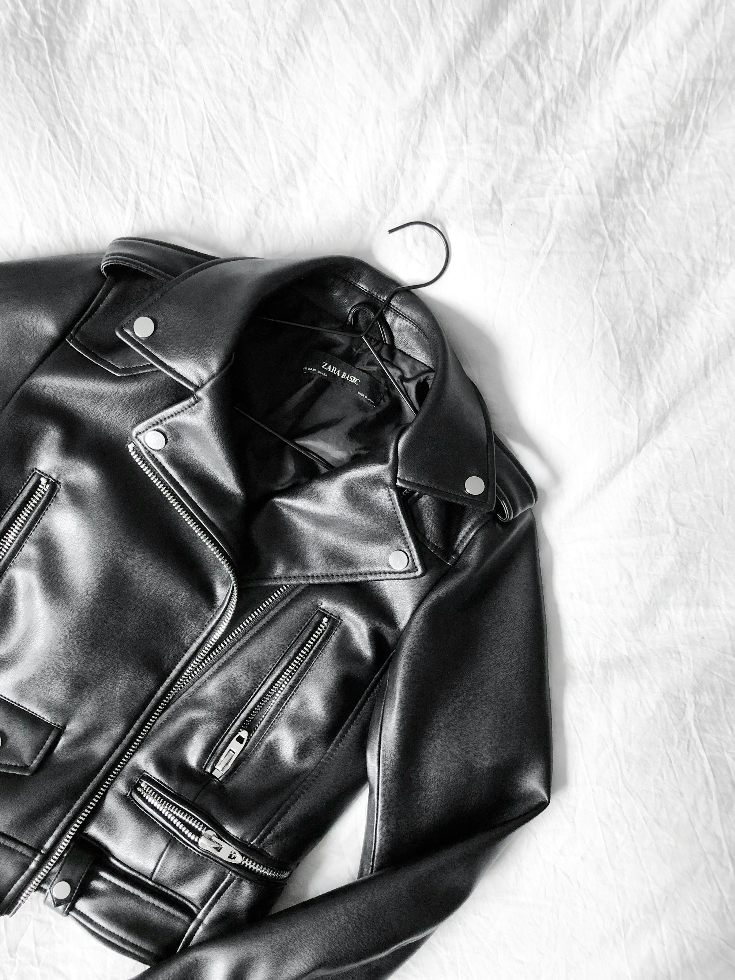 A black jacket lying on a bed | Source: Unsplash