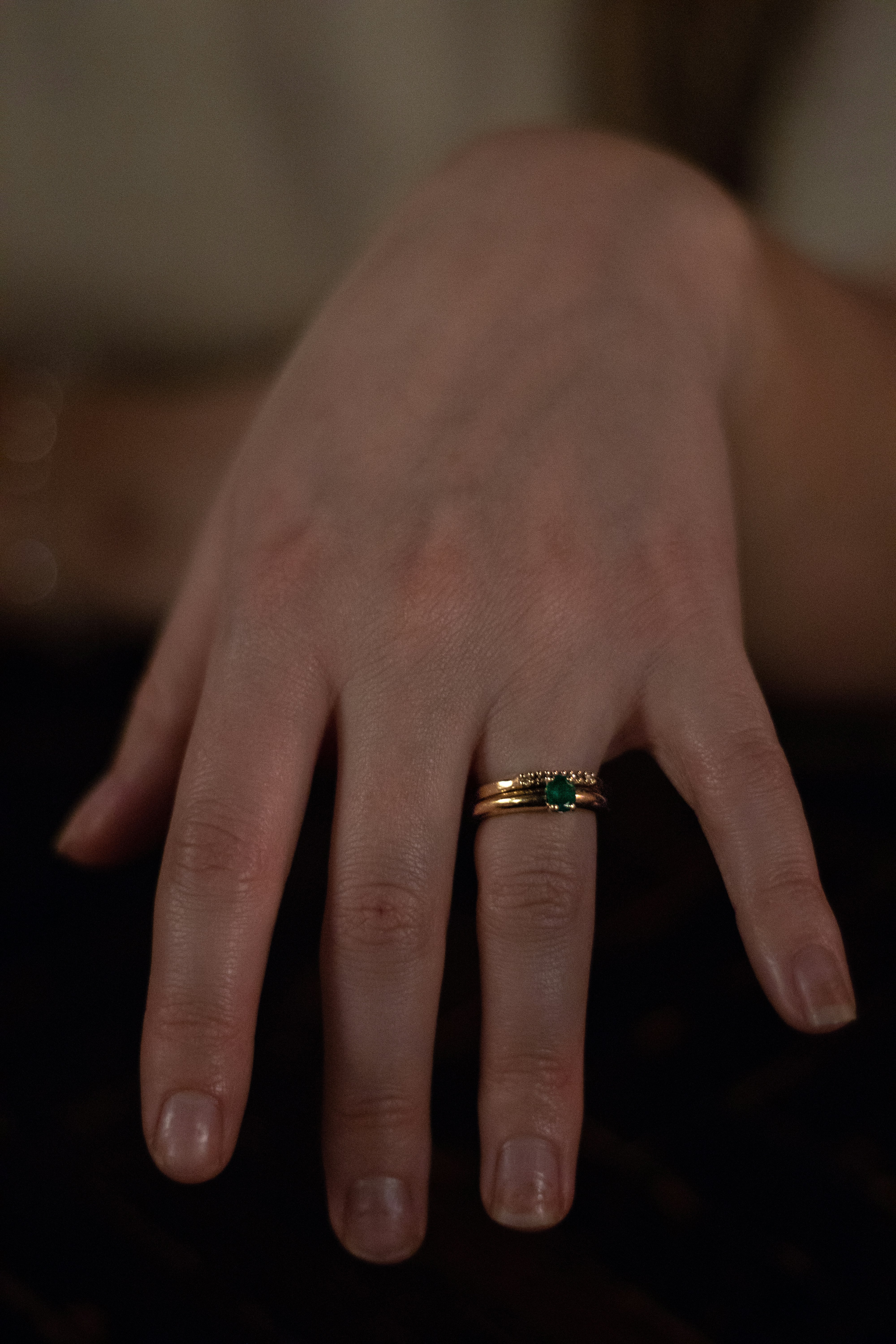 A woman showing off an emerald ring | Source: Unsplash
