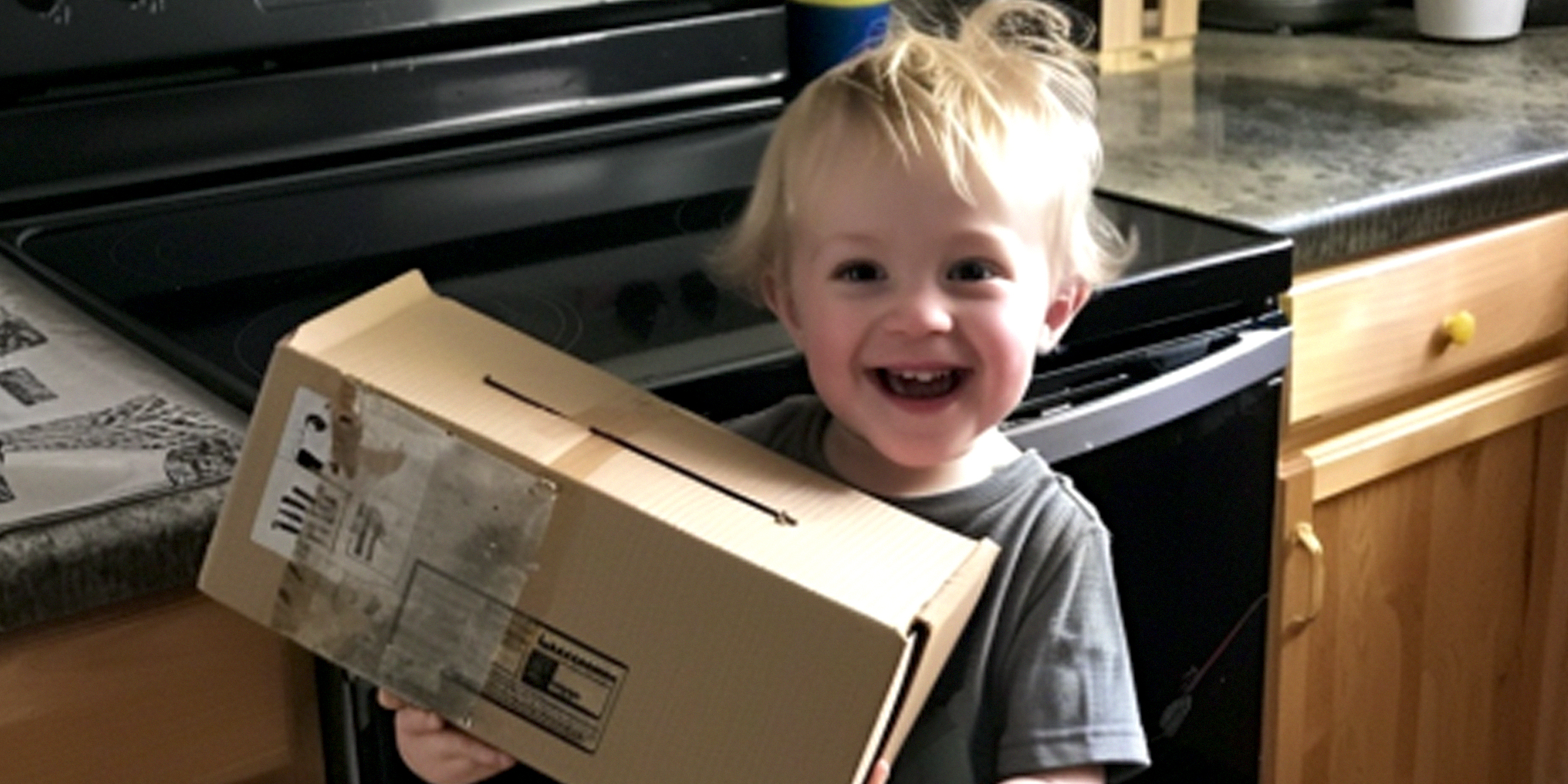 An excited boy holding a box | Source: Amomama