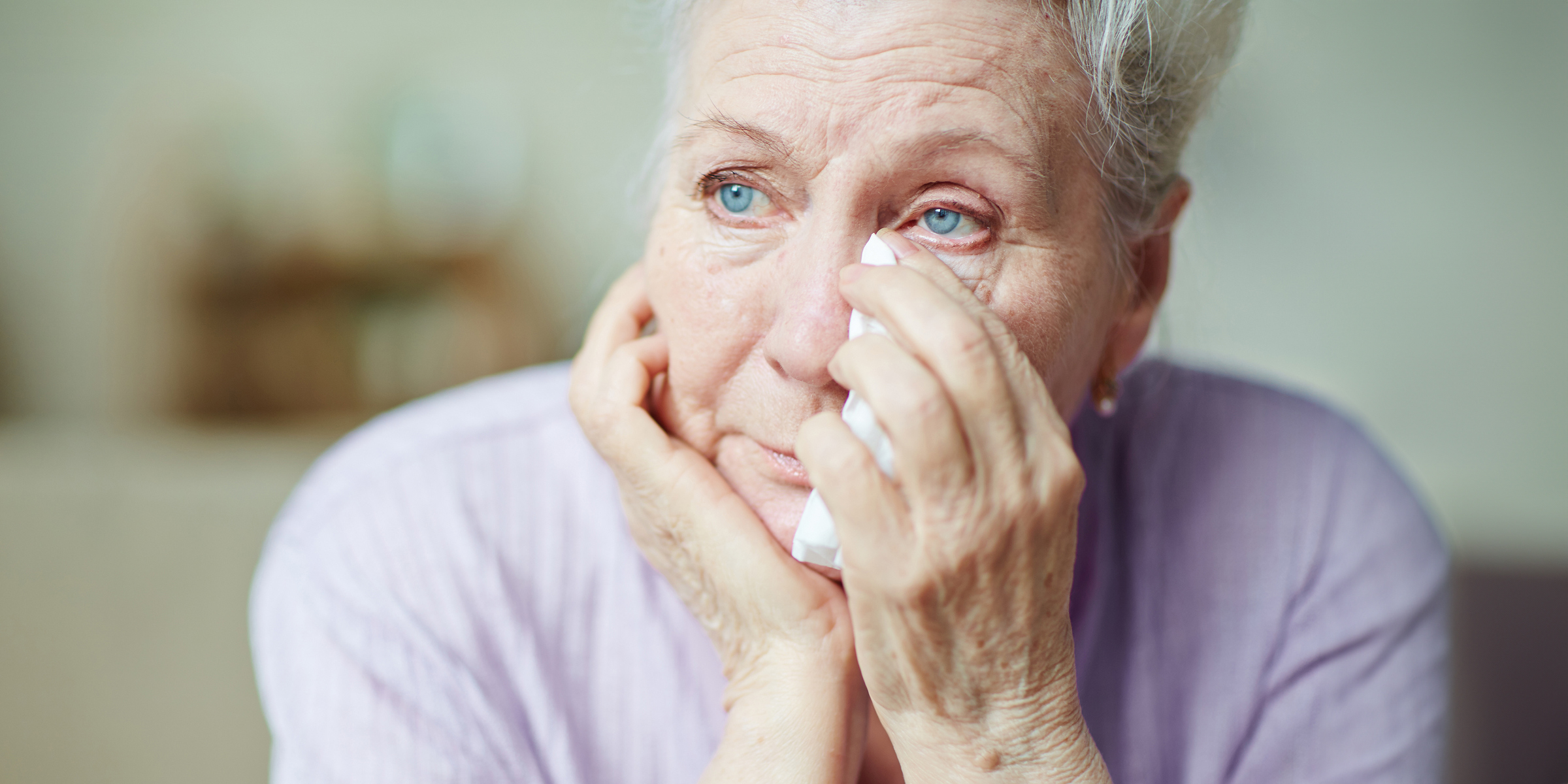 A senior woman wiping her tears | Source: Getty Images