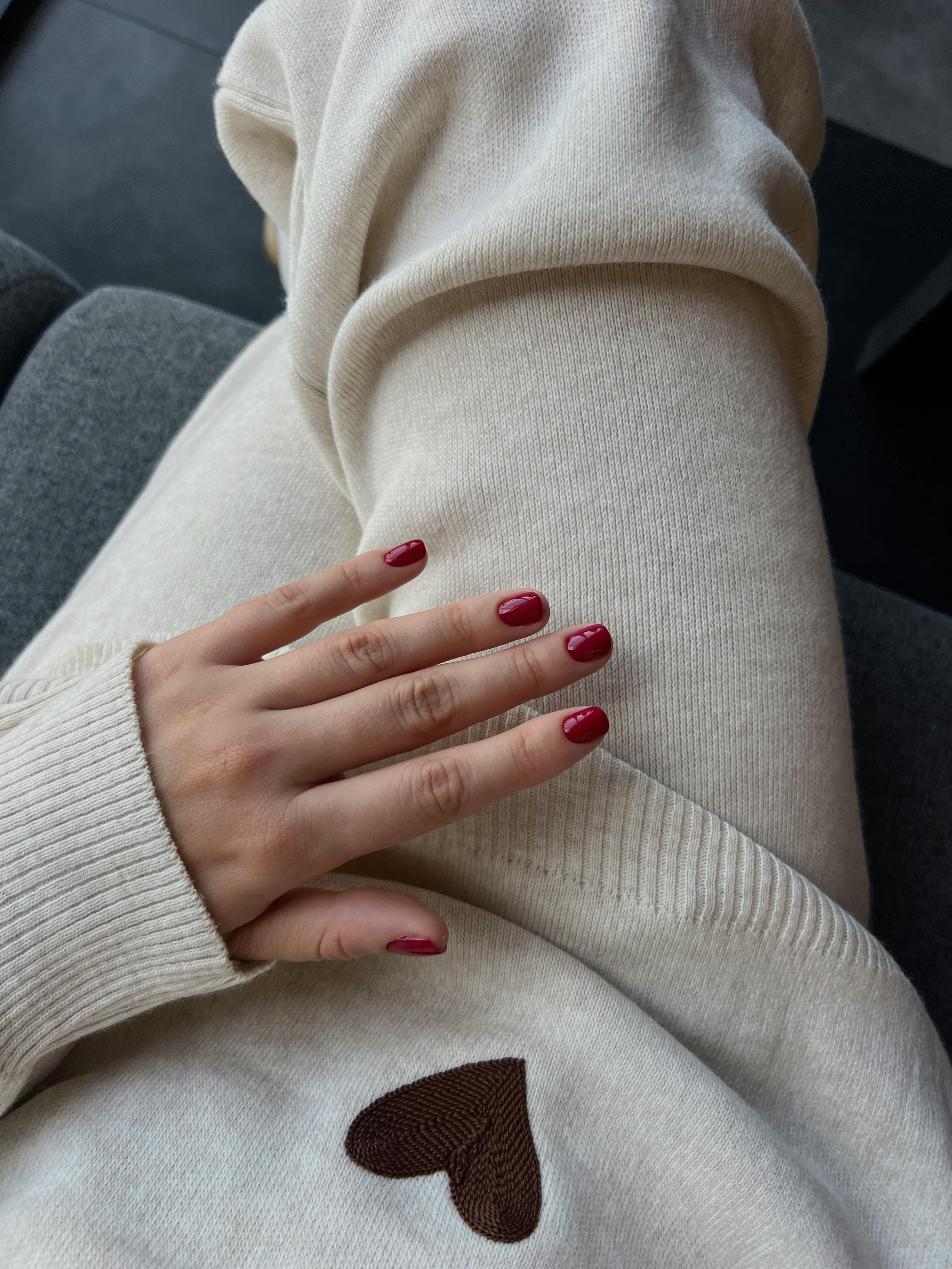A woman with burgundy nail polish | Source: Pexels