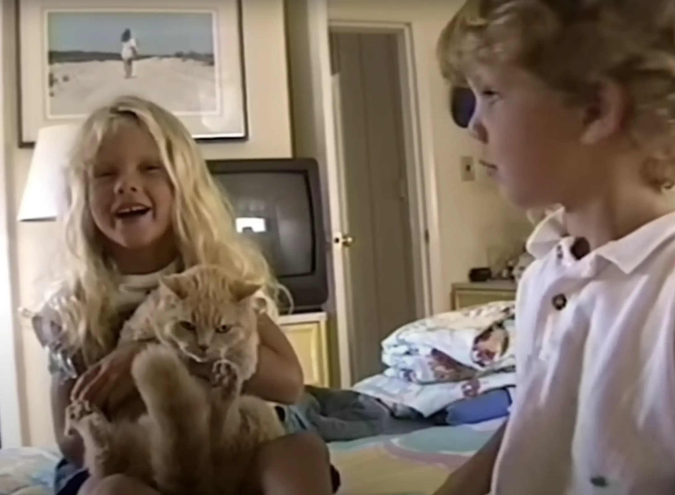 The girl and her brother with their cat | Source: youtube.com/channel/UCqECaJ8Gagnn7YCbPEzWH6g