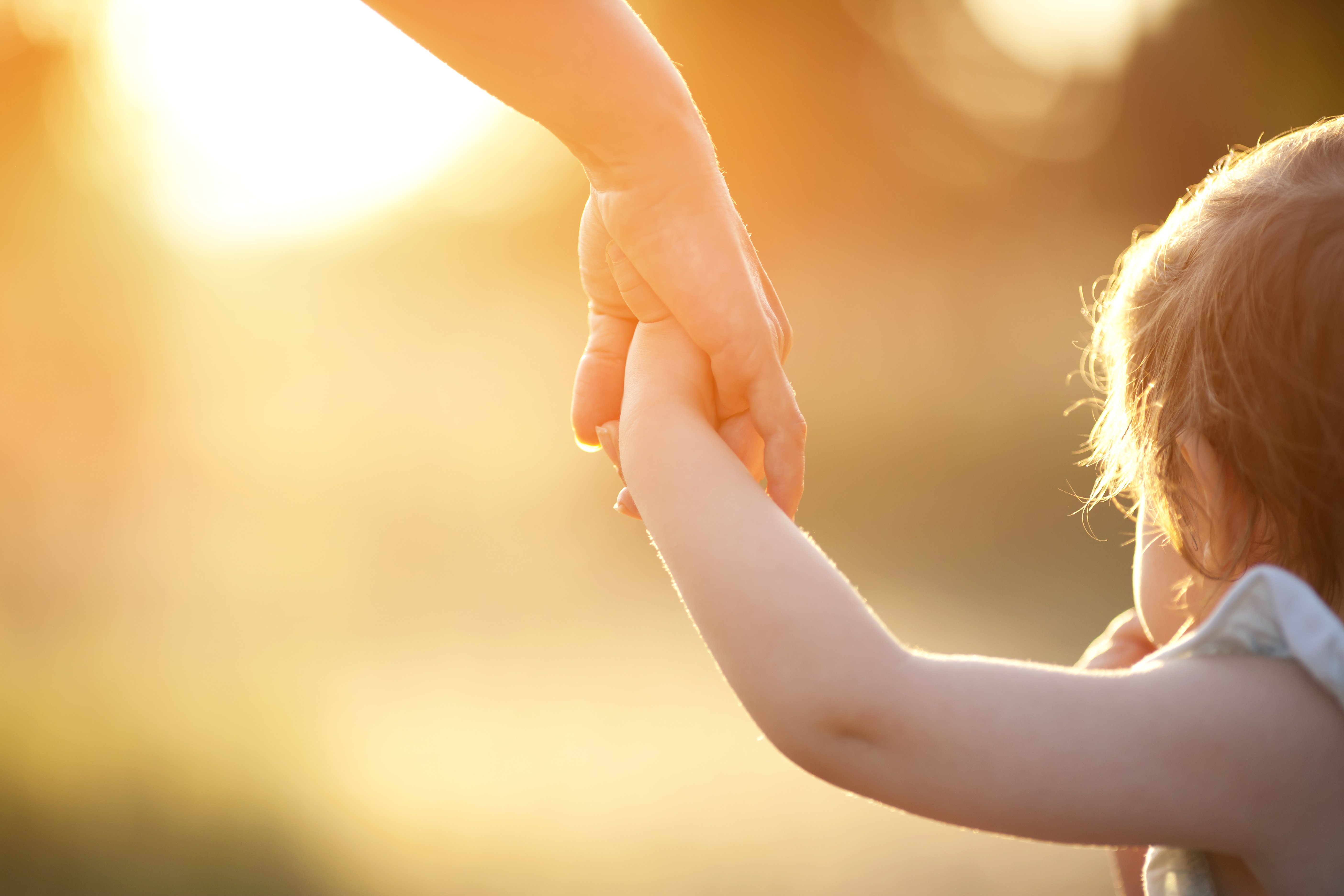 Mother holds baby's hand. | Source: Shutterstock