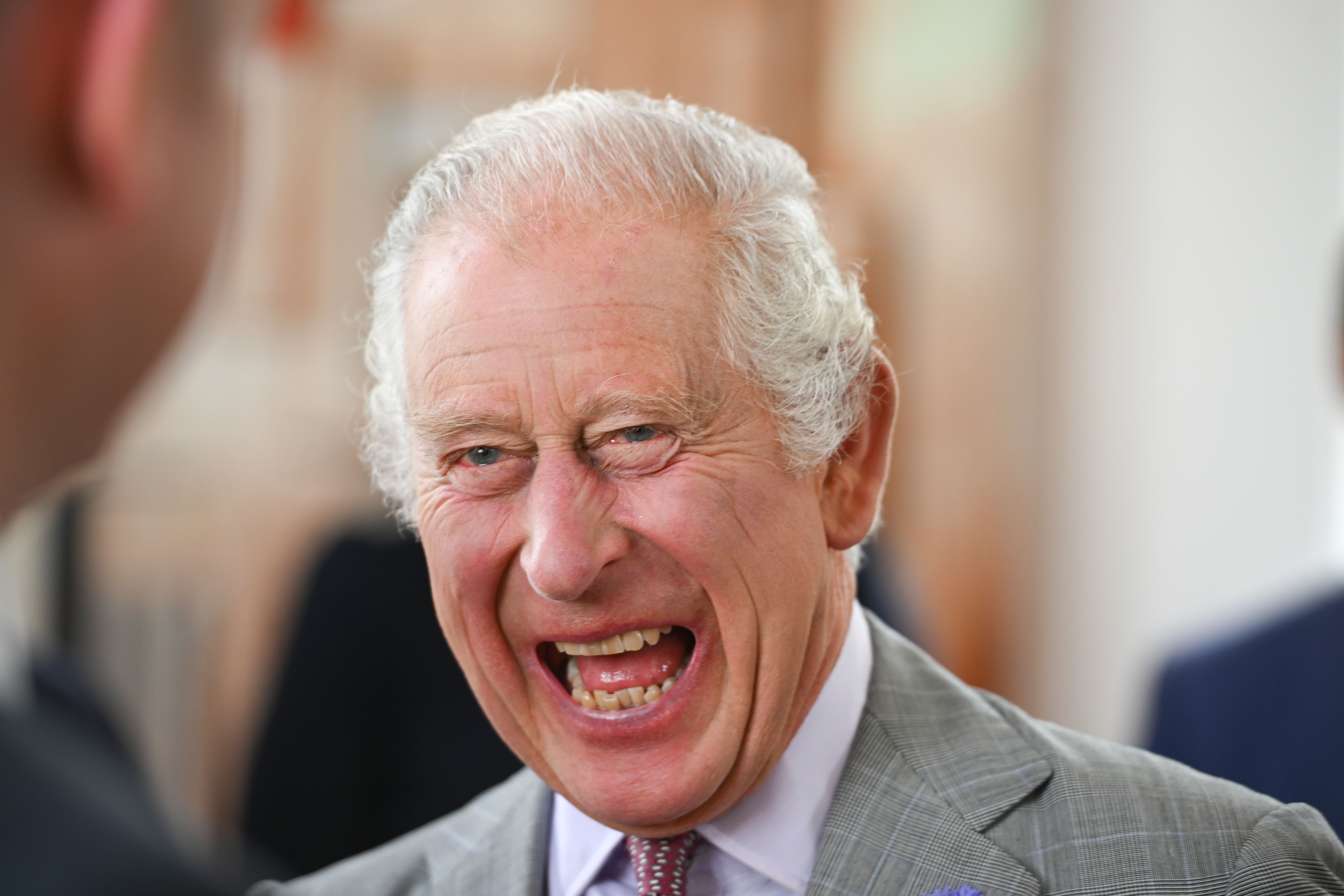 King Charles III laughing during an official visit to Cornwall in St Ives, England on July 13, 2023 | Source: Getty Images