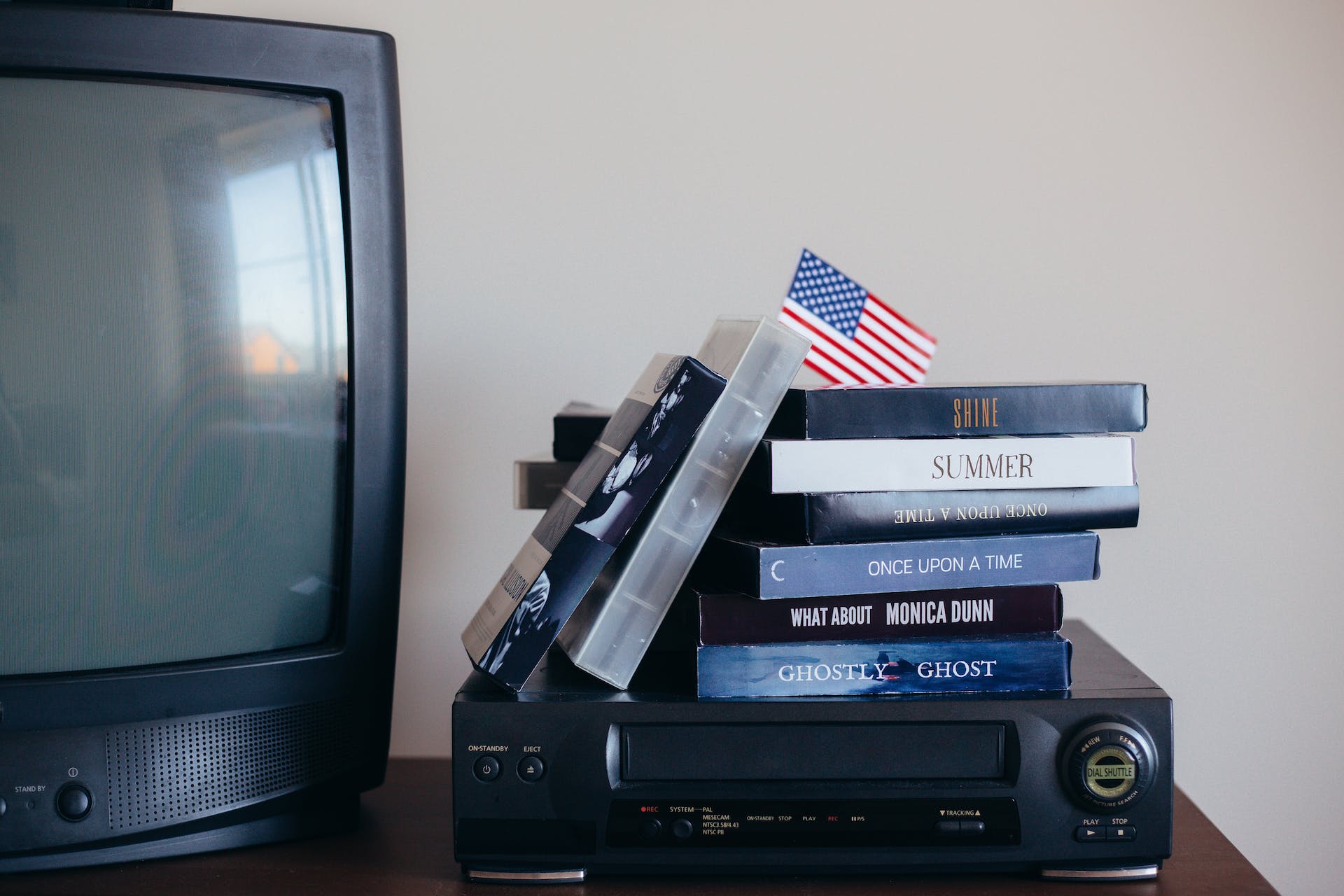 VHS tapes beside a TV | Source: Pexels