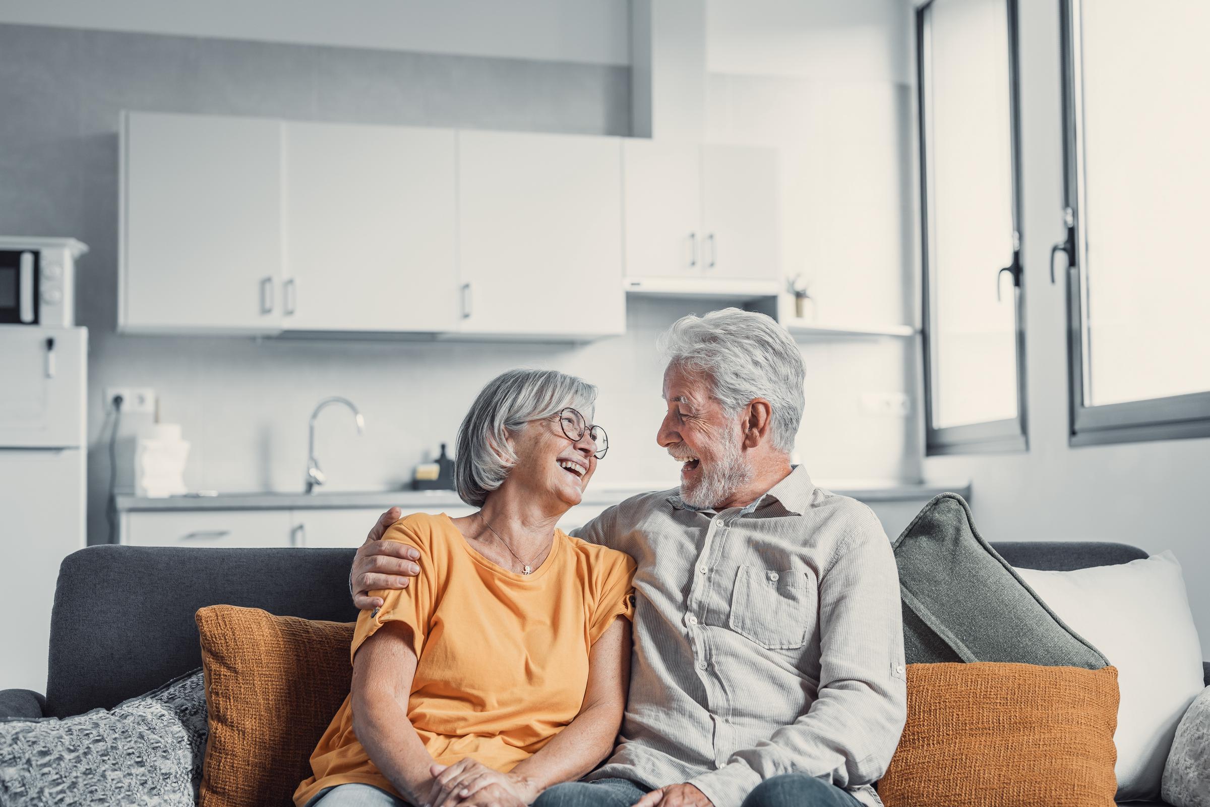 A senior couple smiling at each other at home | Source: Shutterstock