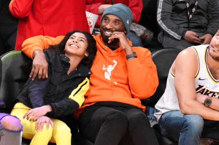 Kobe Bryant hugs daughter Gianna Bryant as they watch a basketball game between the Los Angeles Lakers and the Dallas Mavericks, at Staples Center, on December 29, 2019, in Los Angeles, California | Source: Allen Berezovsky/Getty Images