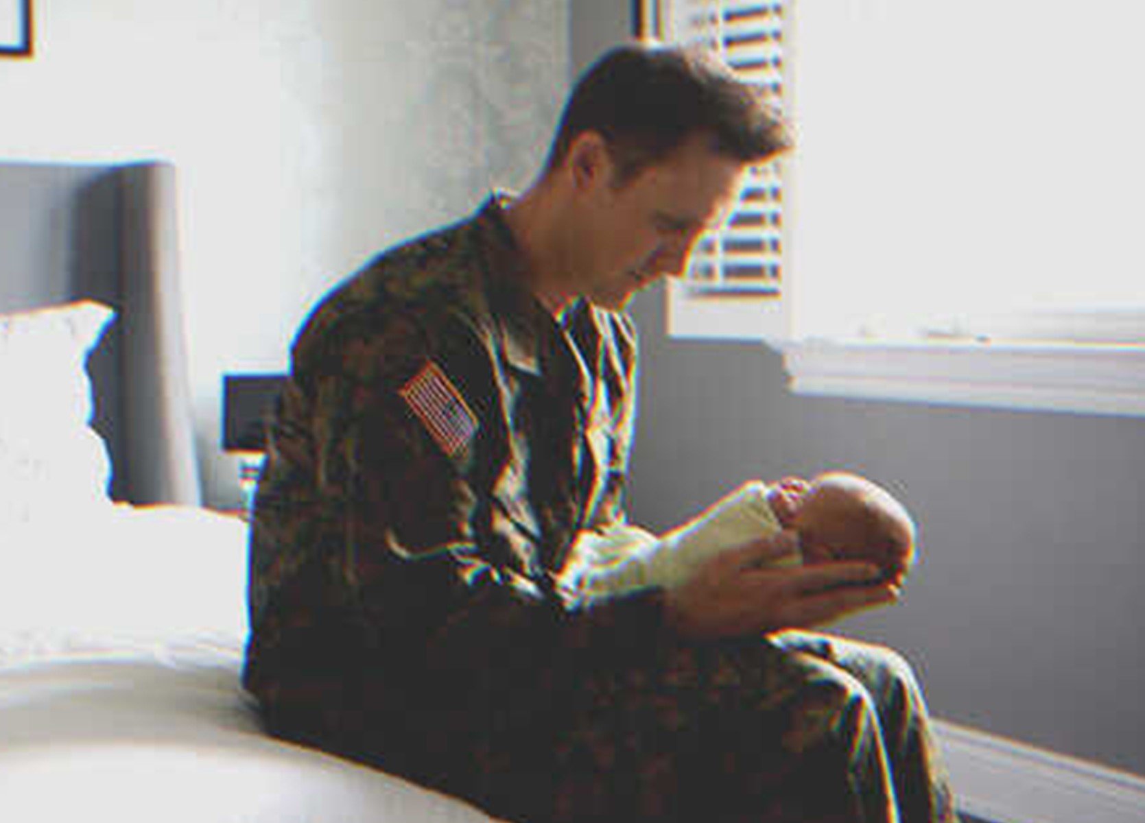 Adam held the tiny baby in his hands. | Source: Shutterstock.com