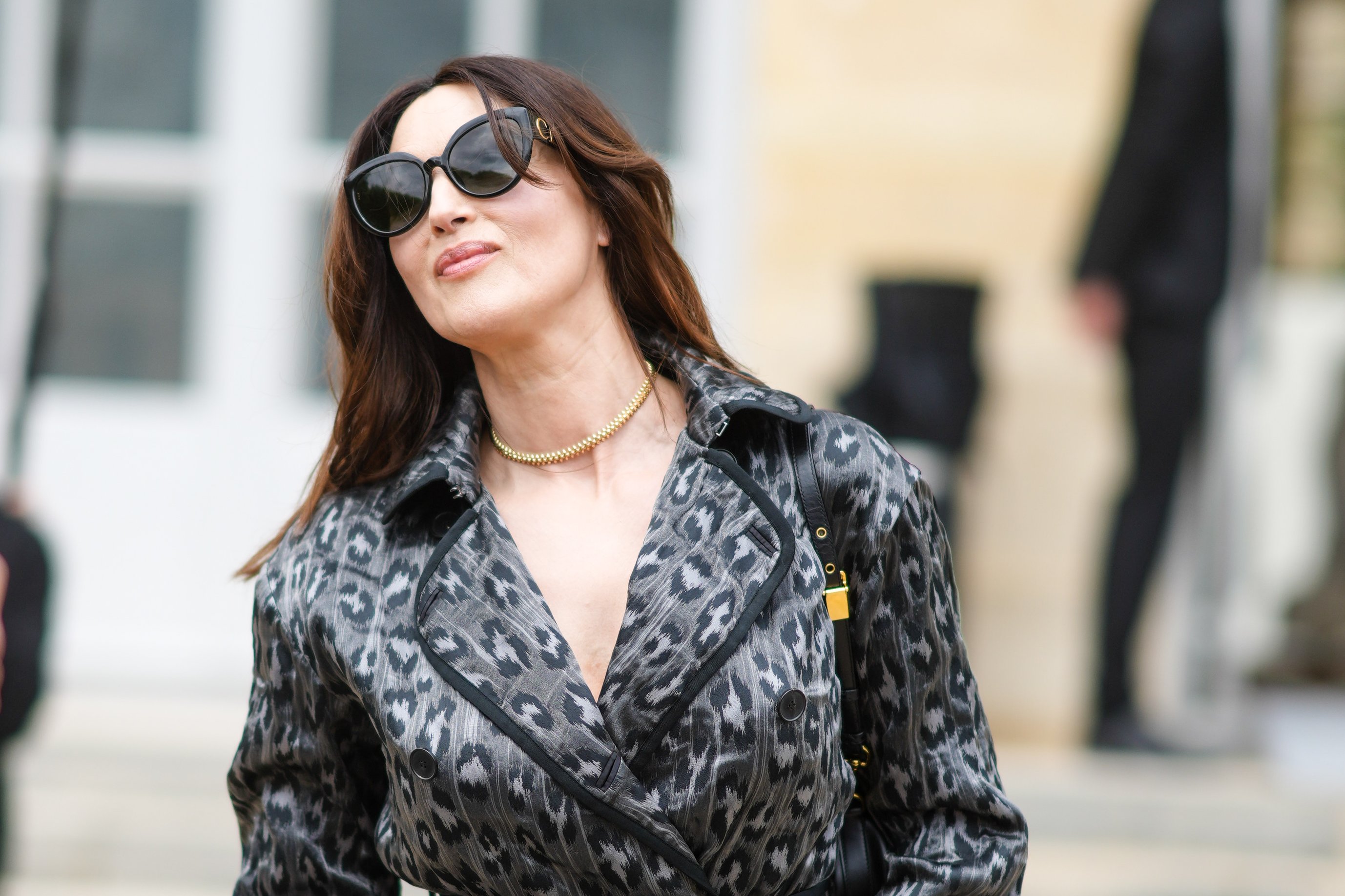 Monica Bellucci wears a trench coat with printed cheetah patterns, outside Dior, during Paris Fashion Week - Haute Couture Fall/Winter 2021/2022, on July 05, 2021 in Paris, France.| Source: Getty Images