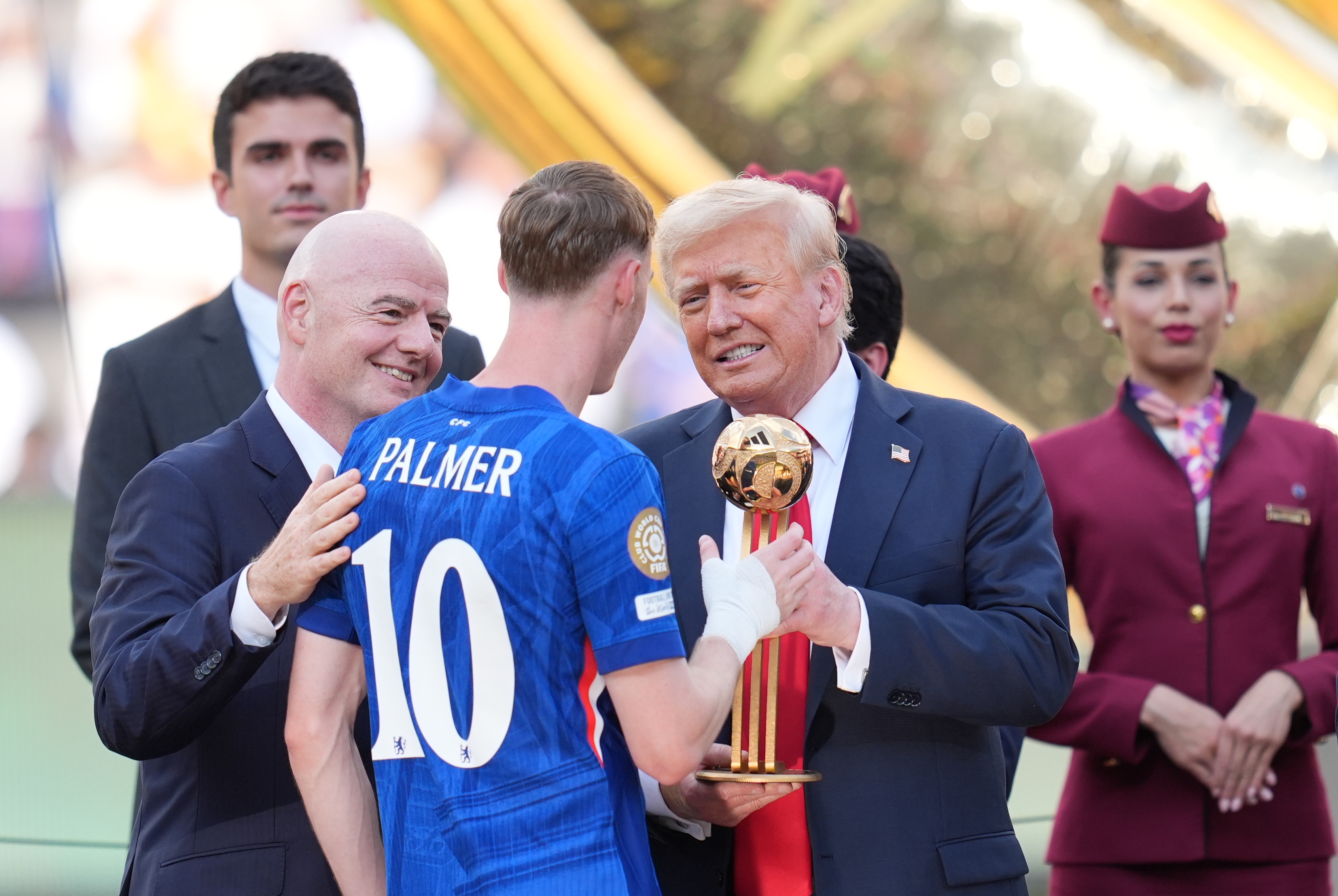 Gianni Infantino and Donald Trump presenting medals to players on July 13, 2025, in New Jersey. | Source: Getty Images
