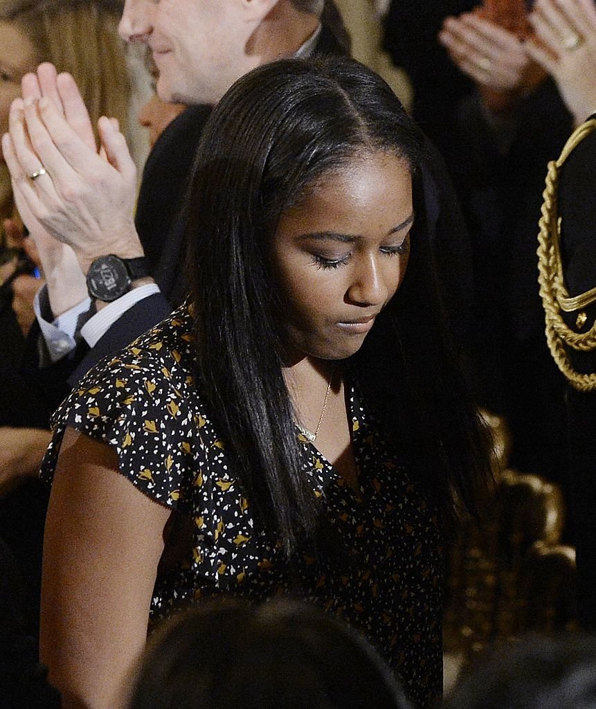 Sasha Obama leaves the State Dining room of the White House | Photo: Getty Images