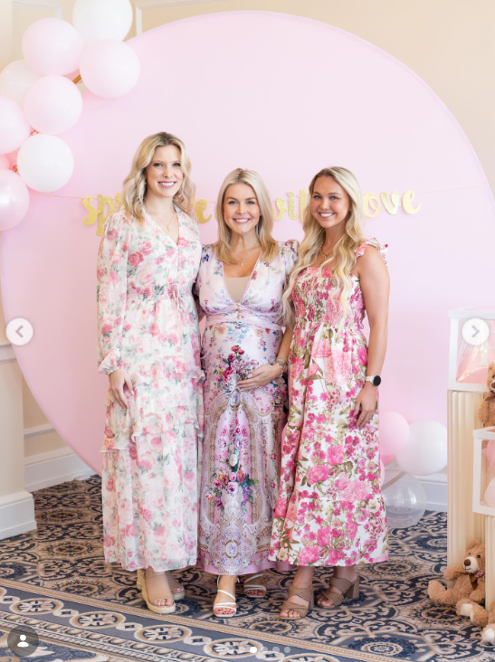 Karoline Leavitt poses with guests in front of a pink backdrop during the celebration | Source: Instagram/kieghan.nangle