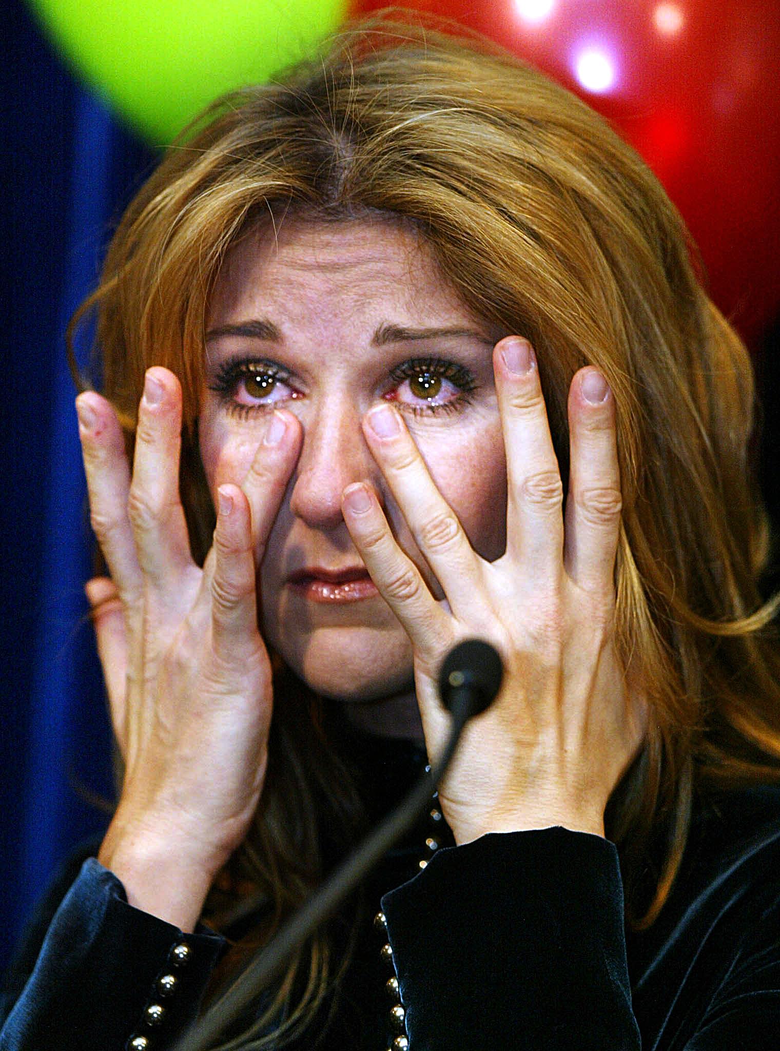 Celine Dion wipes away tears while speaking at Sainte-Justine Children's Hospital in Montreal, Canada on December 18, 2002. | Source: Getty Images