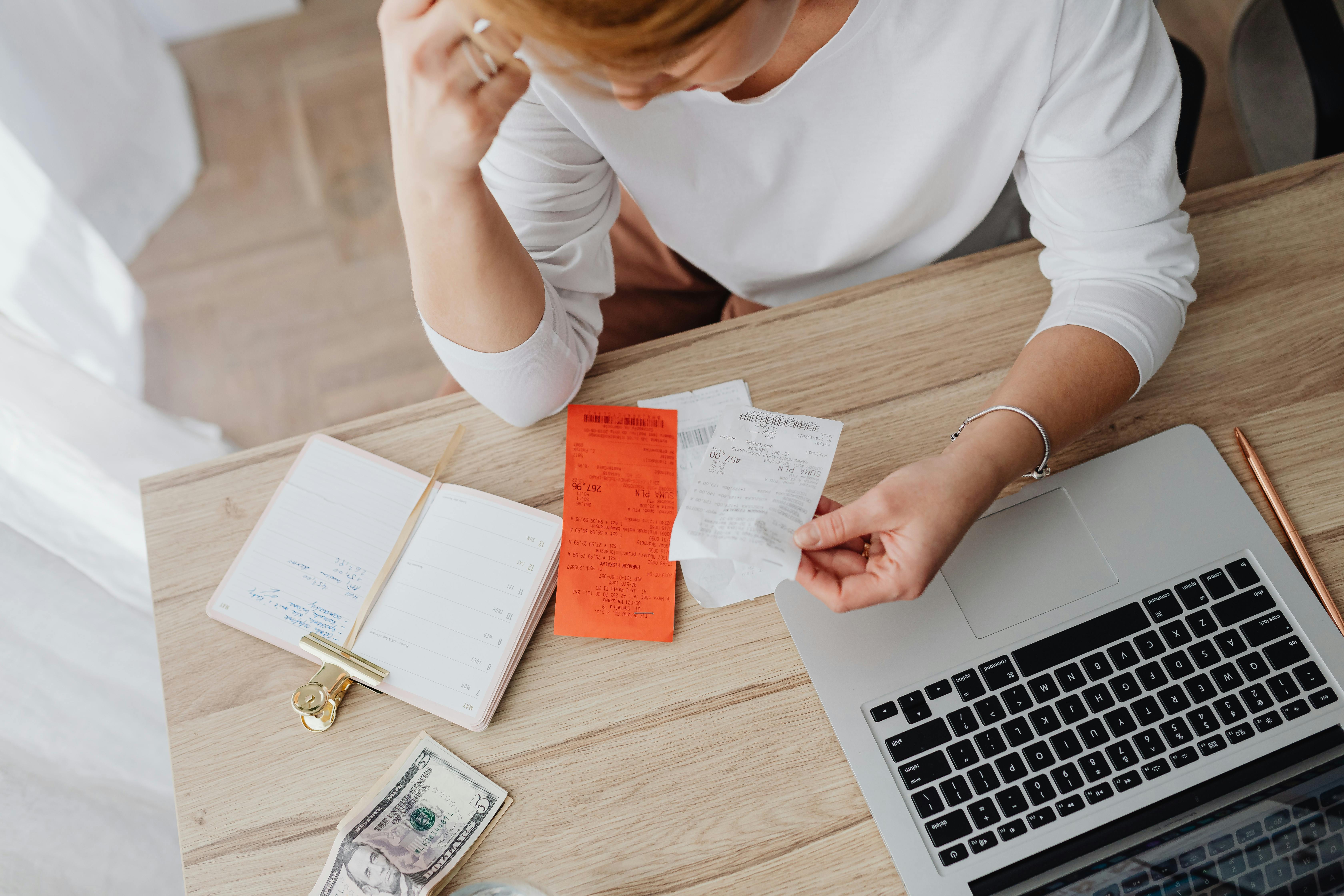 A woman looking over receipts | Source: Pexels