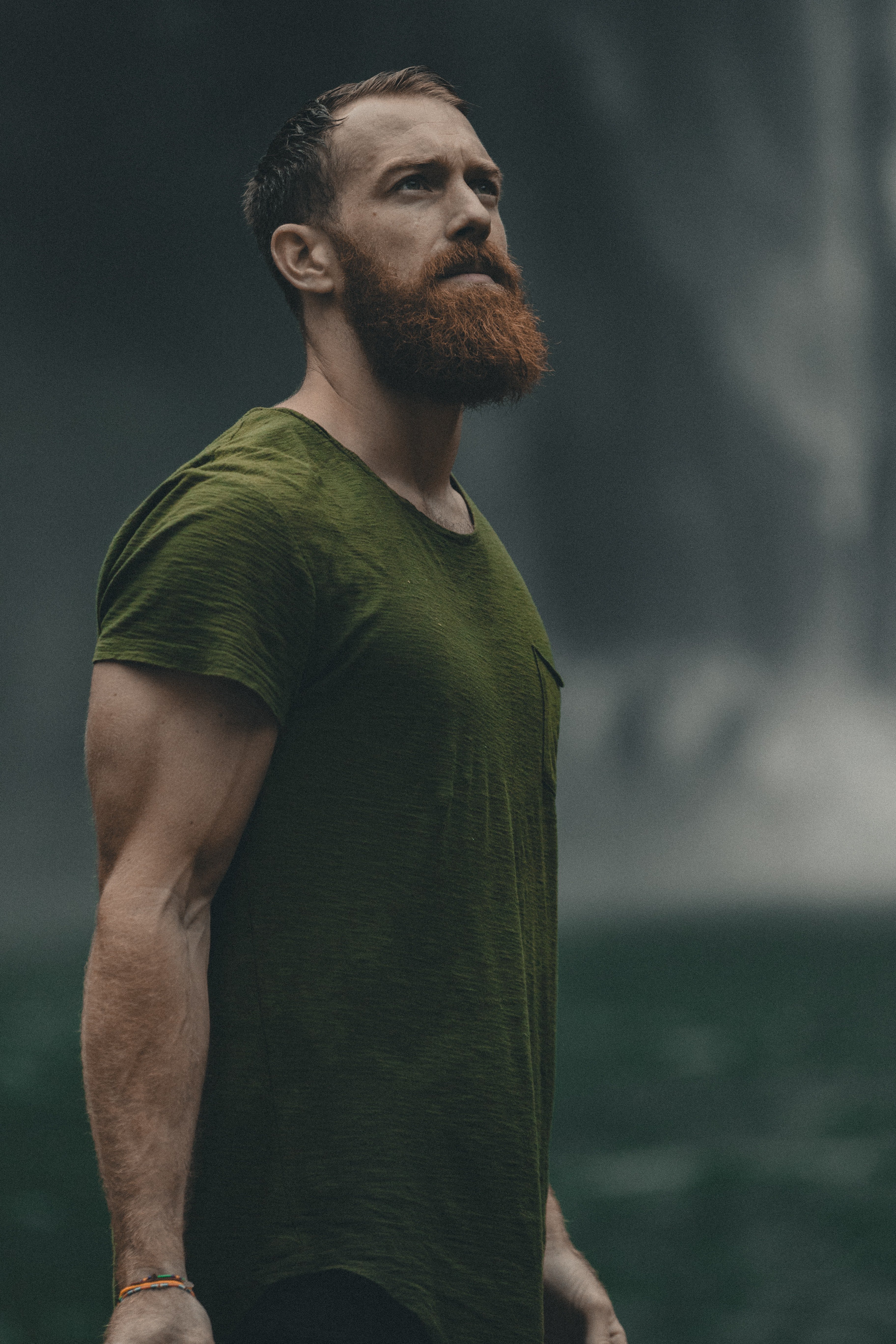 Bearded man wearing a green T-shirt | Source: Unsplash / Jakob Owens