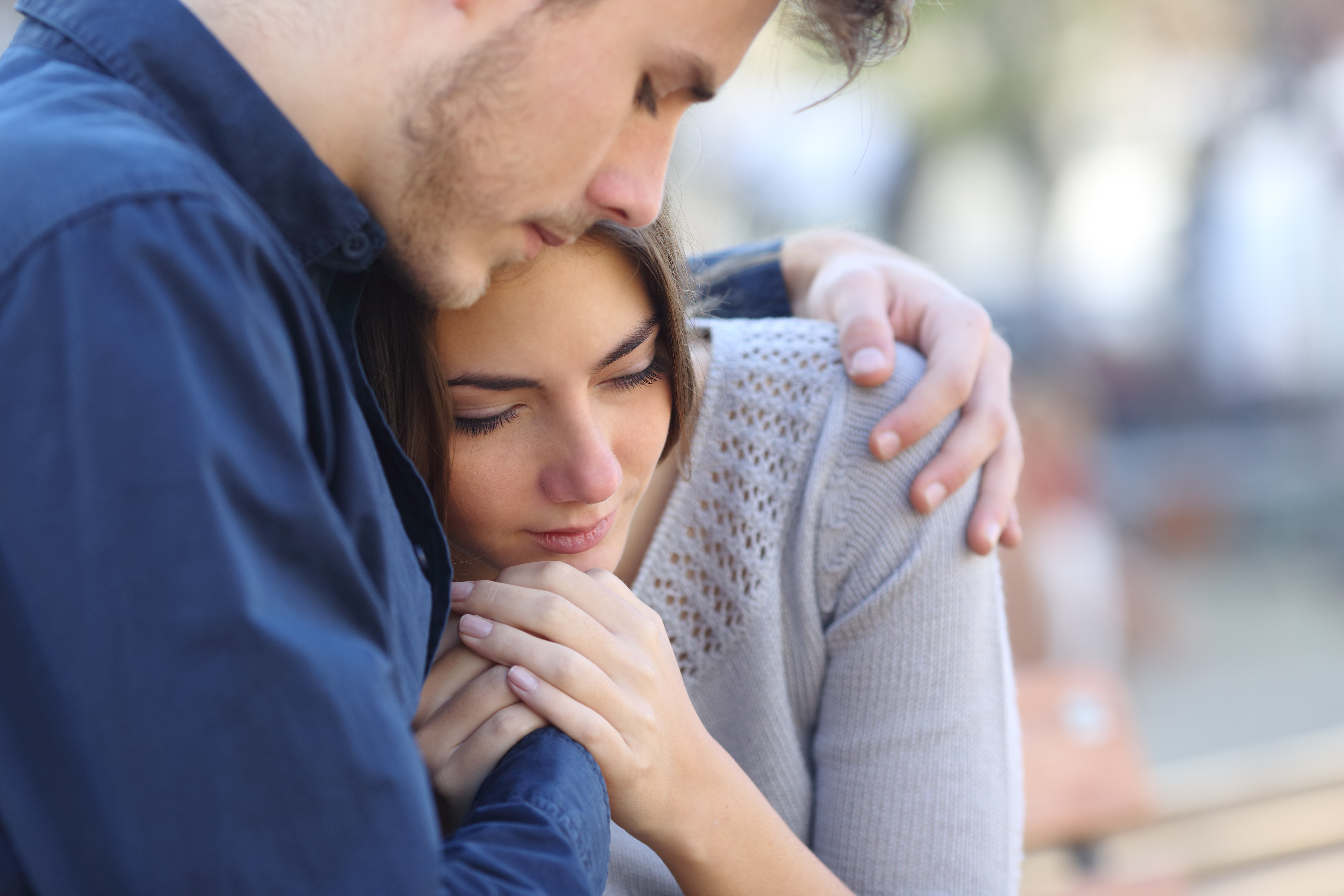 Man hugs his sad girlfriend | Source: Shutterstock.com