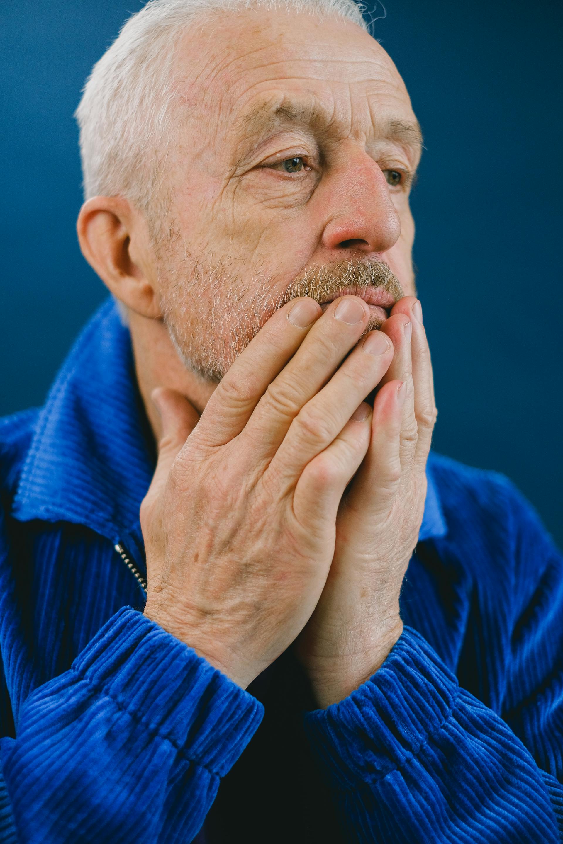 A senior man covering his mouth with his hands | Source: Pexels