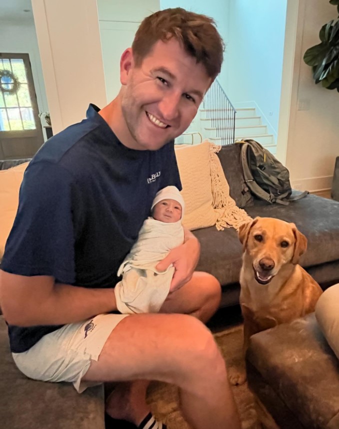 Connor Smith posing with newborn son, Wesley Alan Smith, and family dog, Ryman, in a post made on June 27, 2024 | Source: Facebook/Mattie Jackson Smith