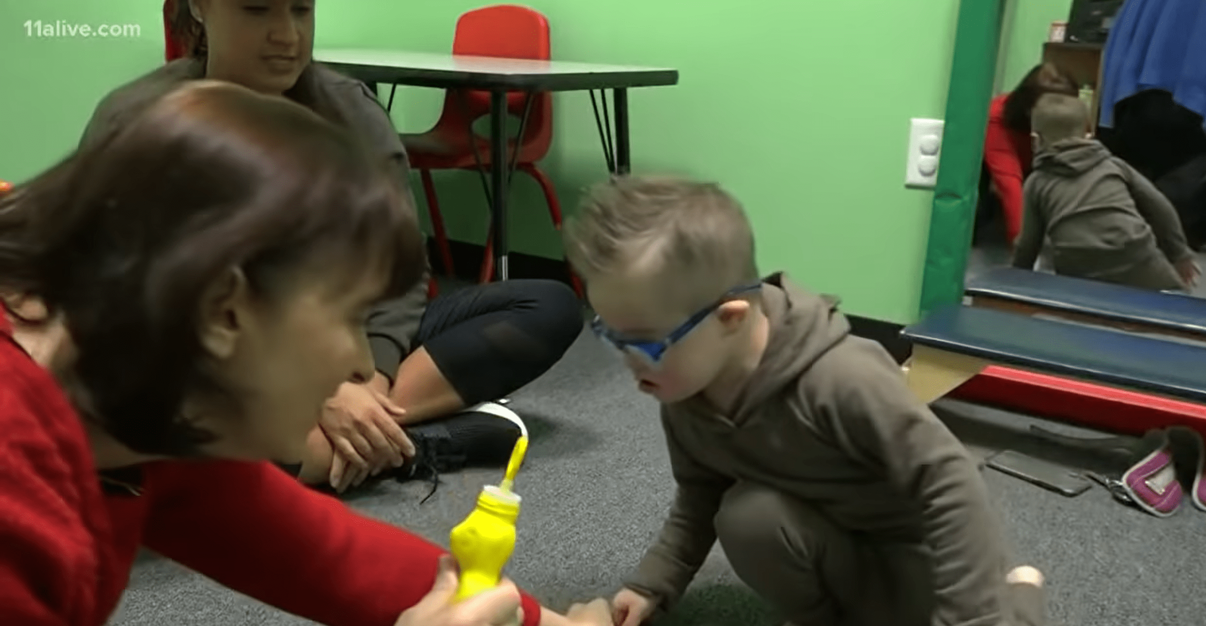 Special needs son playing with his mom. | Photo: YouTube/11Alive