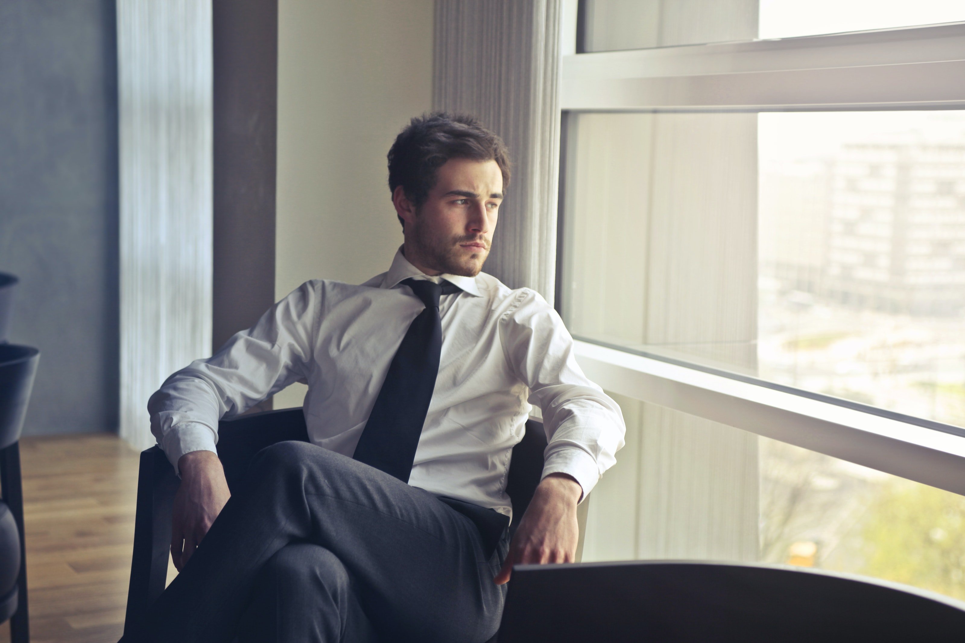 A man looks outside the window. | Photo: Pexels