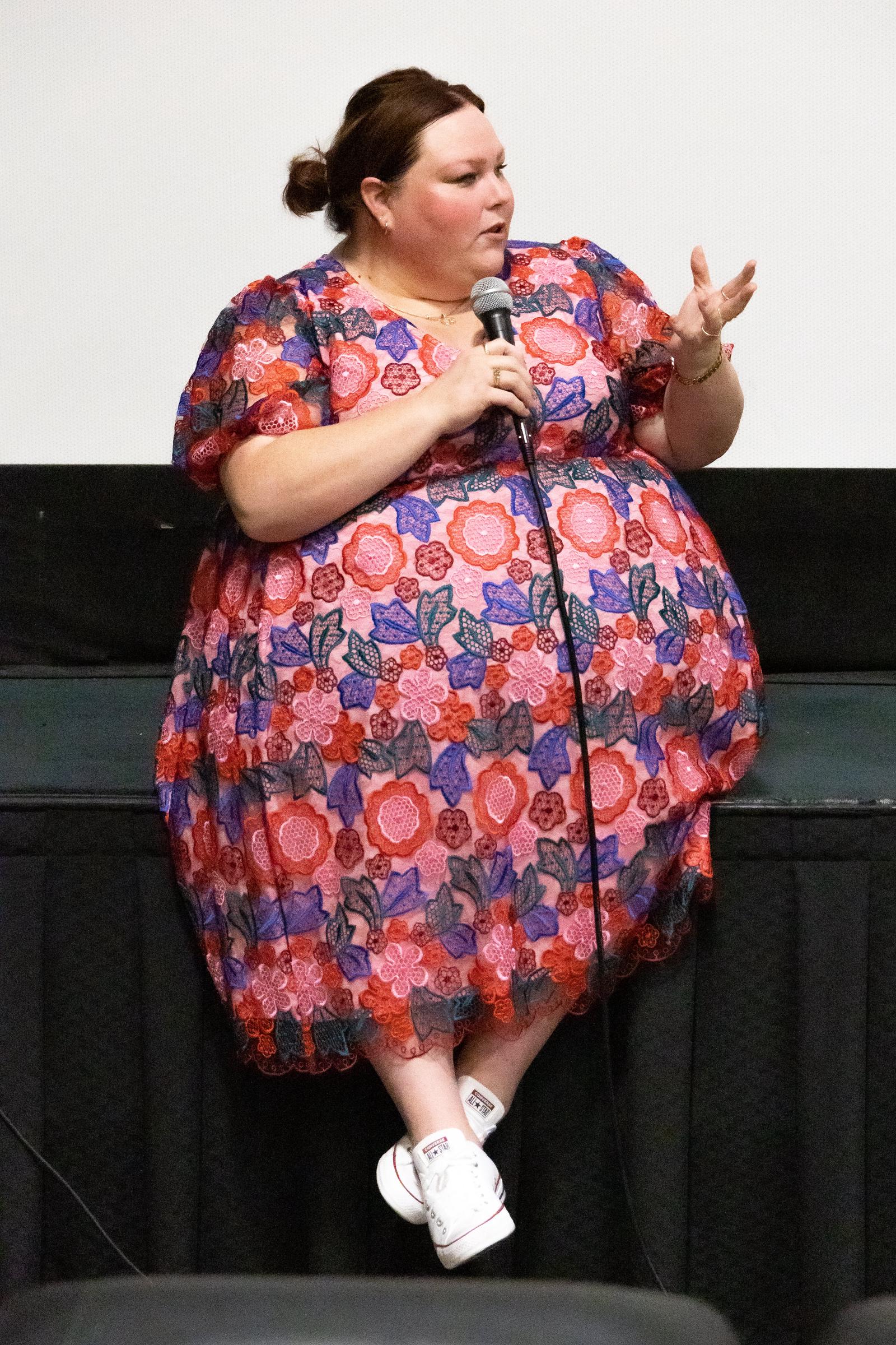 At a Q&A for "Stay Awake," Metz wore a colorful floral dress with white sneakers. The casual styling gives a different view of her appearance than the red carpet photos in the gallery.