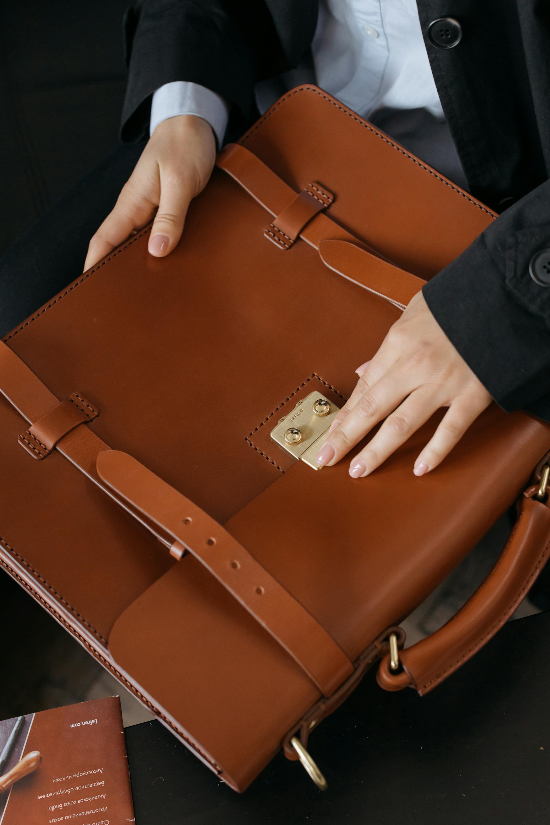 A woman holding a leather briefcase | Source: Pexels