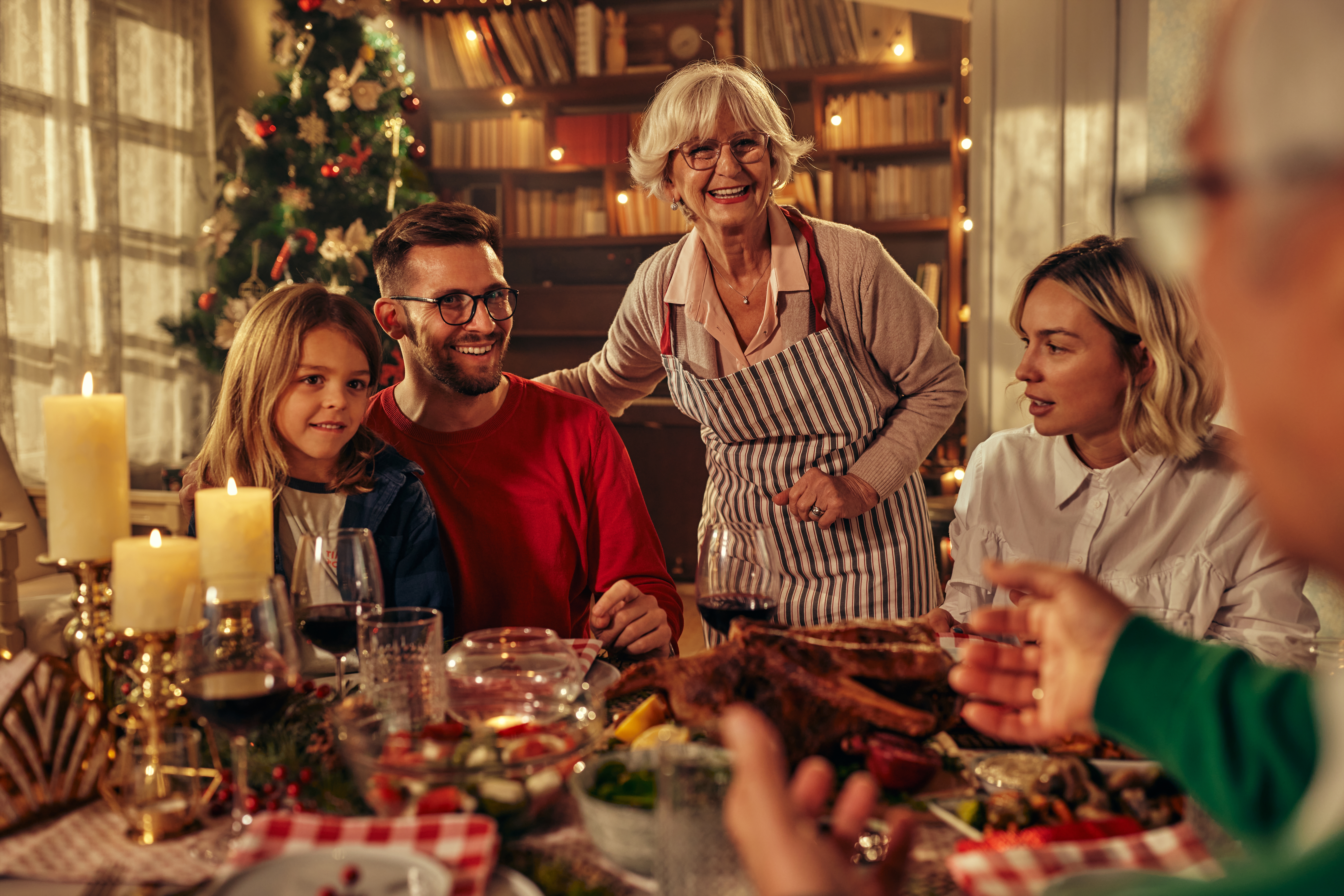 Family members gathered at a Christmas supper party | Source: Shutterstock