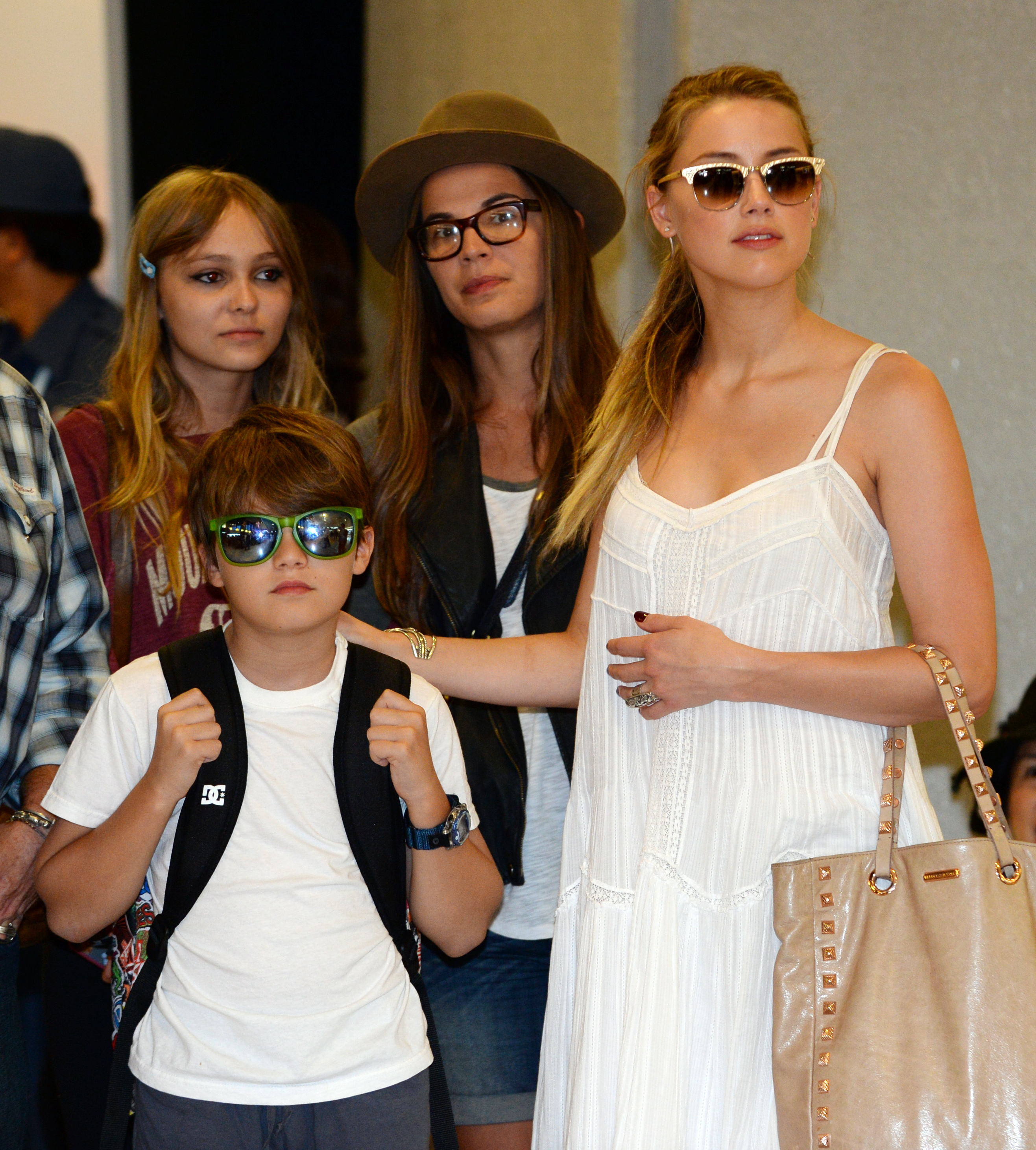 Jack and Lily-Rose Depp with Amber Heard in Narita, Japan, 2013 | Source: Getty Images