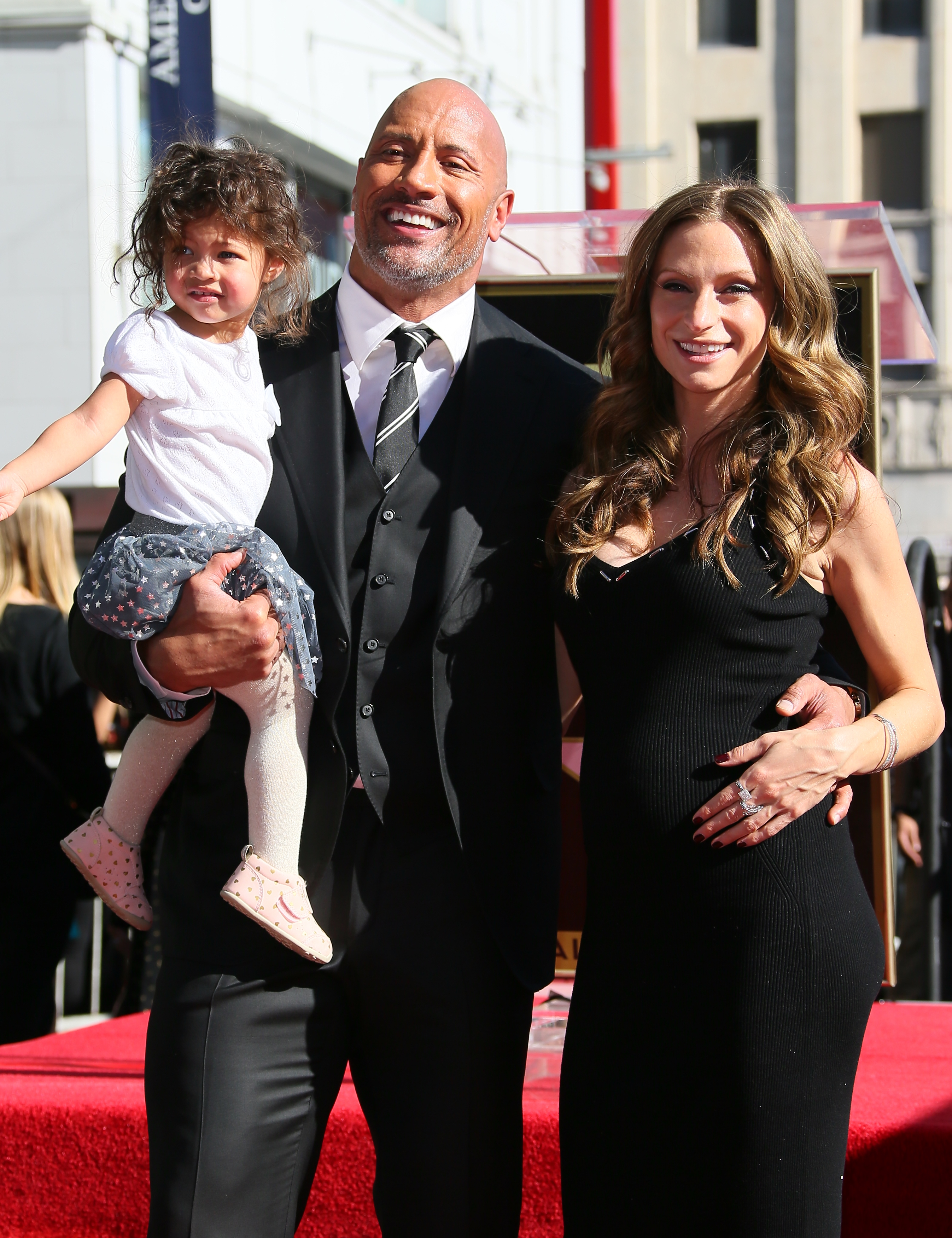 Dwayne Johnson, Lauren Hashian and Jasmine Johnson attend a ceremony honoring him with a star on The Hollywood Walk of Fame on December 13, 2017 | Source: Getty Images