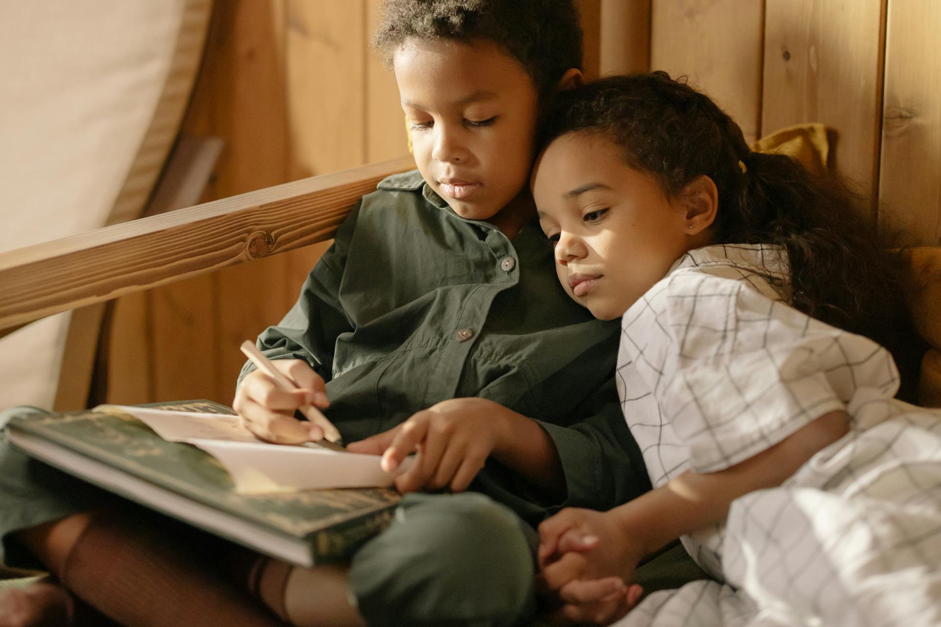 A boy and girl reading | Source: Pexels