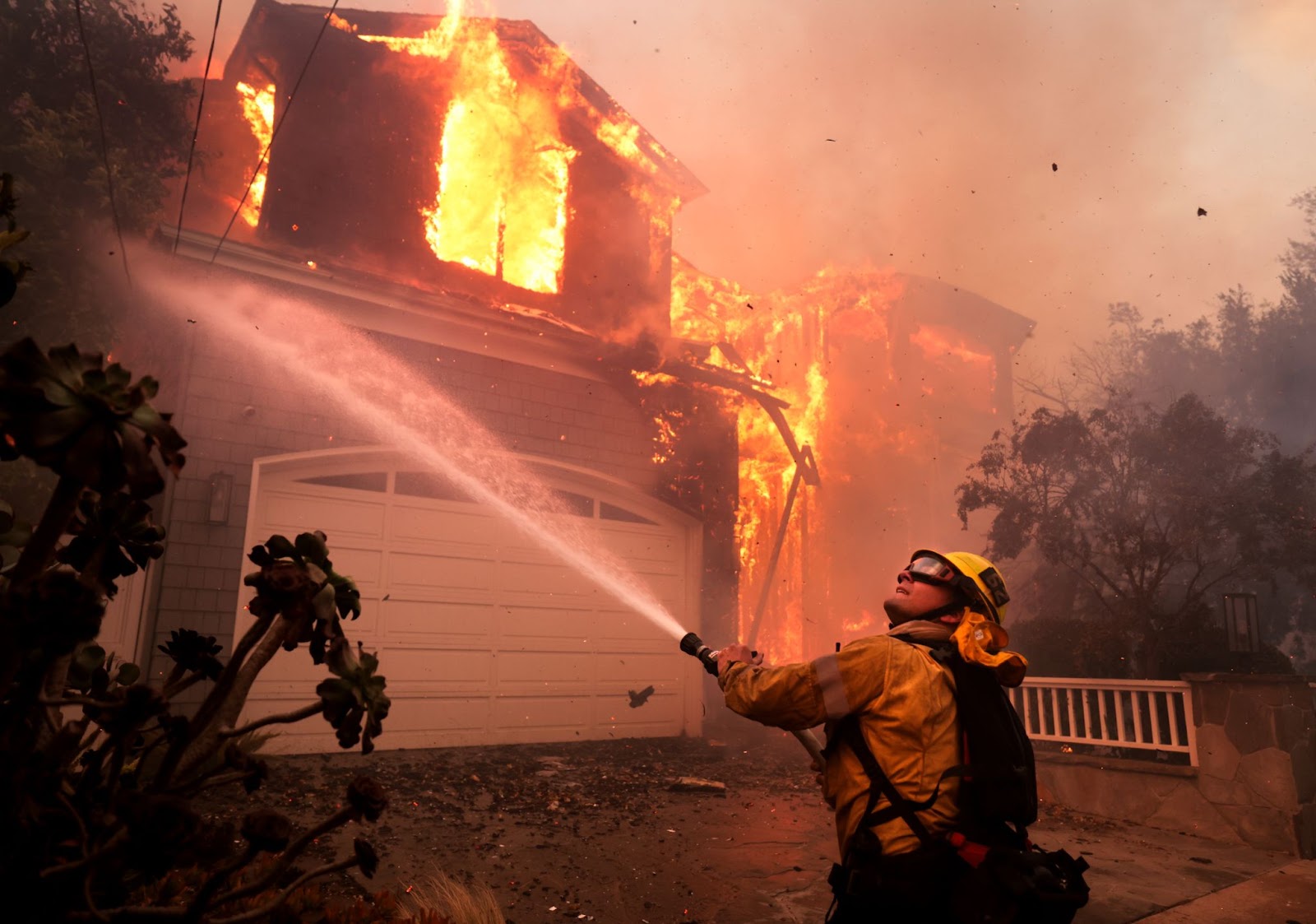 A firefighter battling a house fire in Pacific Palisades, California, on January 7, 2025. | Source: Getty Images