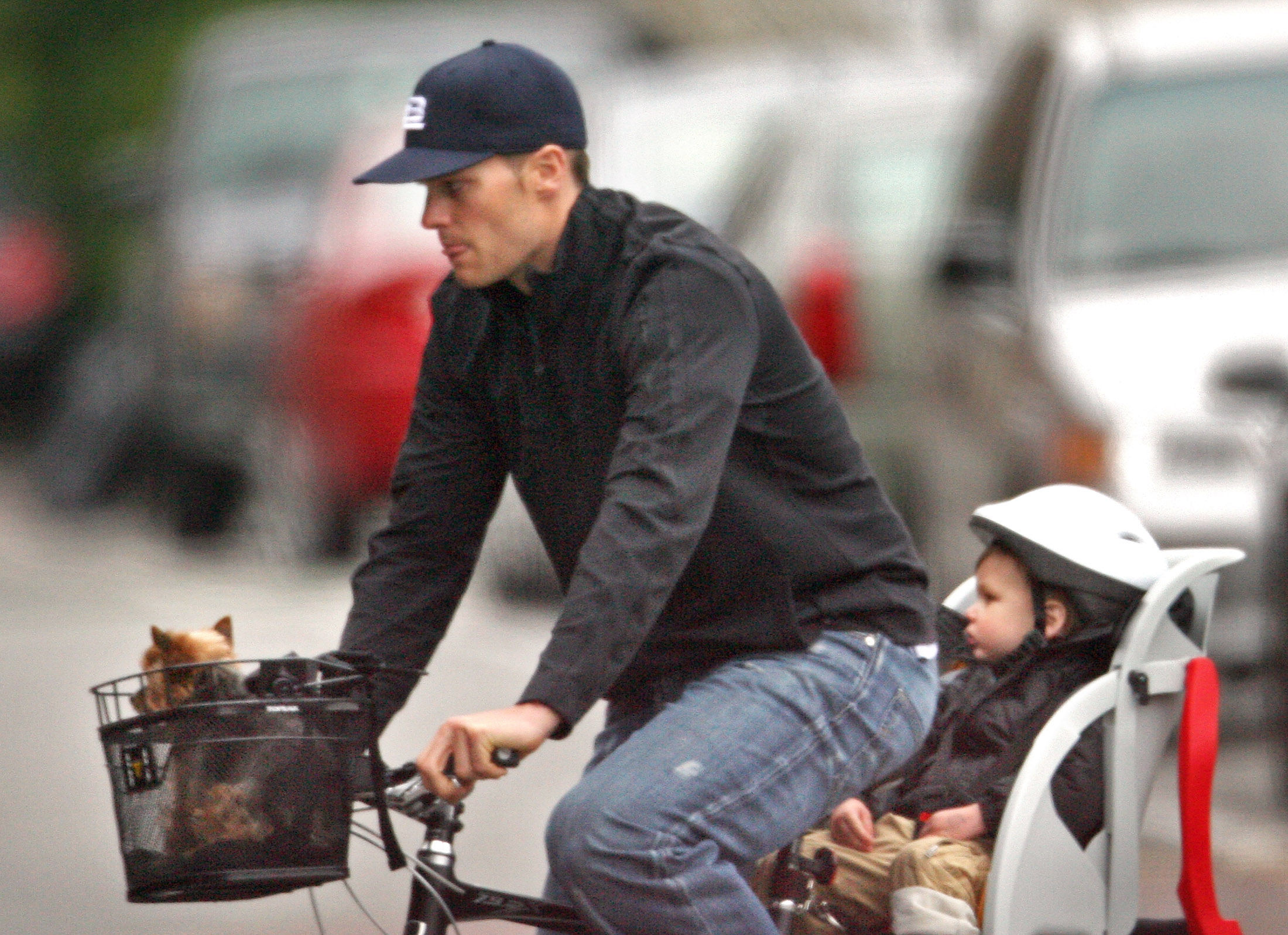 Tom Brady pedals through Boston with his son John "Jack" Edward Thomas Moynahan riding behind him and Gisele Bündchen's dog, Vida, perched in the front basket, capturing an intimate glimpse of their everyday life.