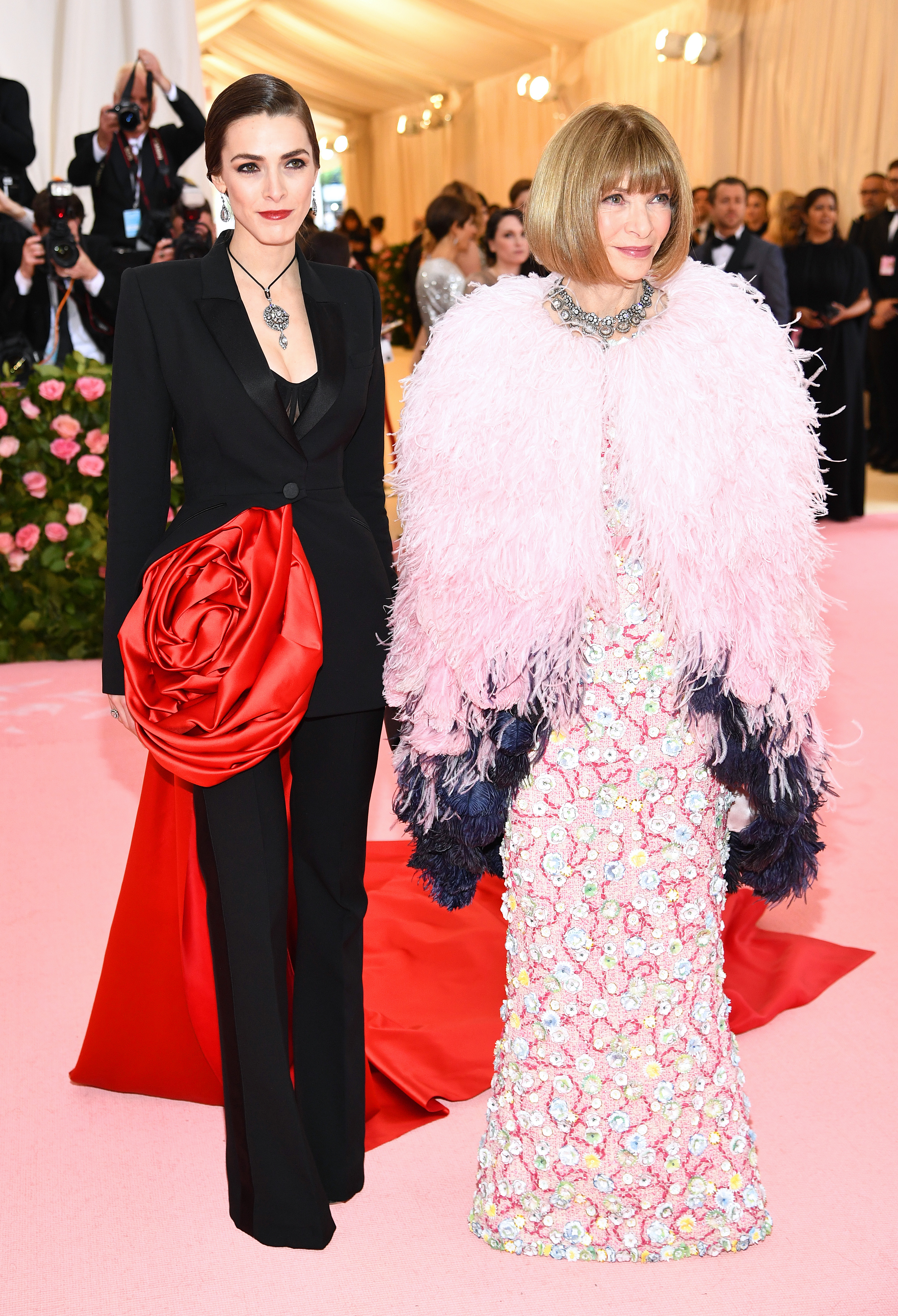 Bee Shaffer kept her look elegant with an oversized red rose on a black suit while her mother, Anna Wintour, opted for a fully feathered look at the Met Gala celebrating "Camp: Notes on Fashion" on May 6, 2019, in New York City.