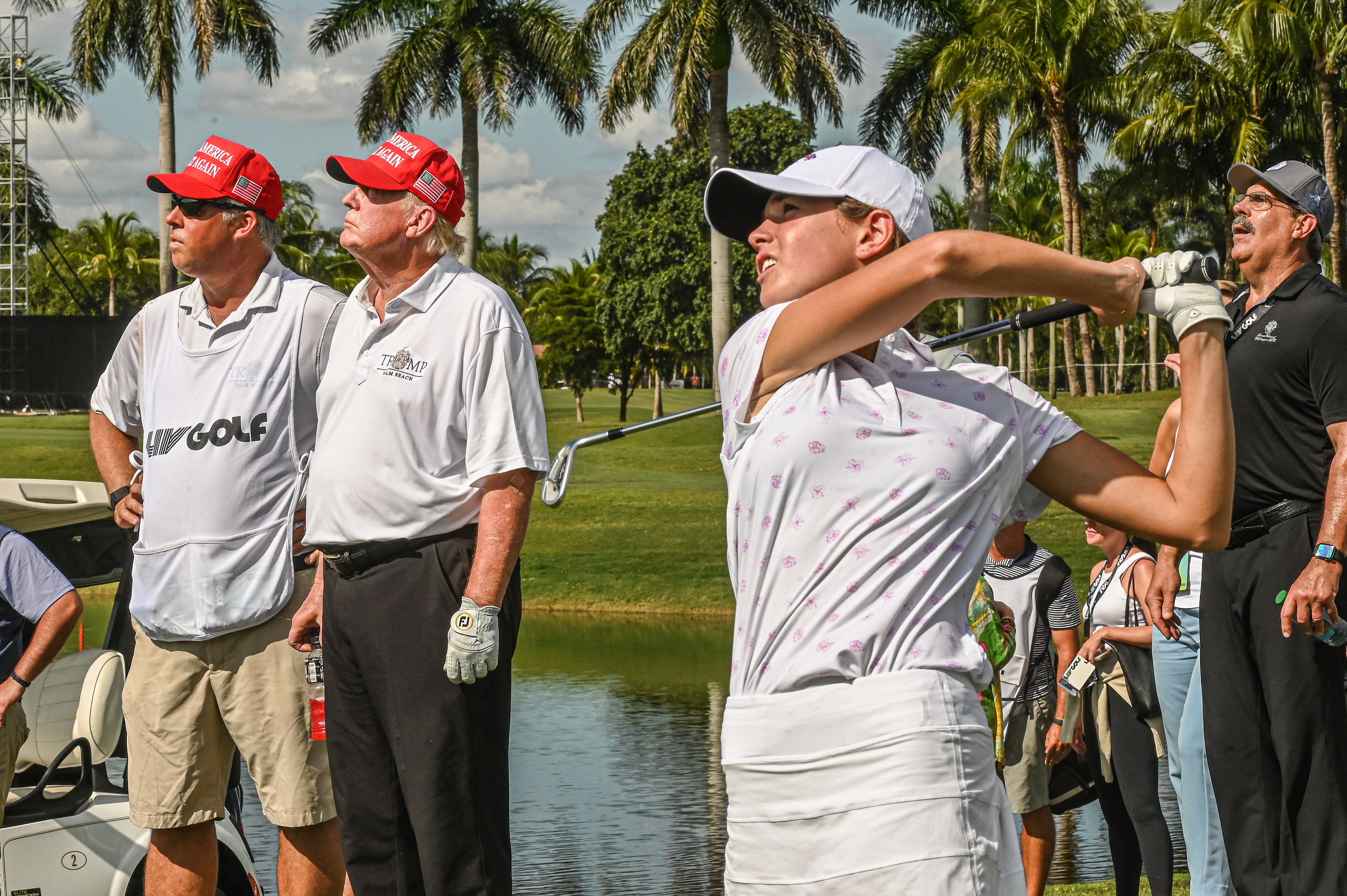 President Donald Trump (2nd L) watches his granddaughter, Kai Trump, play golf at Trump National Doral Miami golf club on October 27, 2022, in Miami, Florida | Source: Getty Images